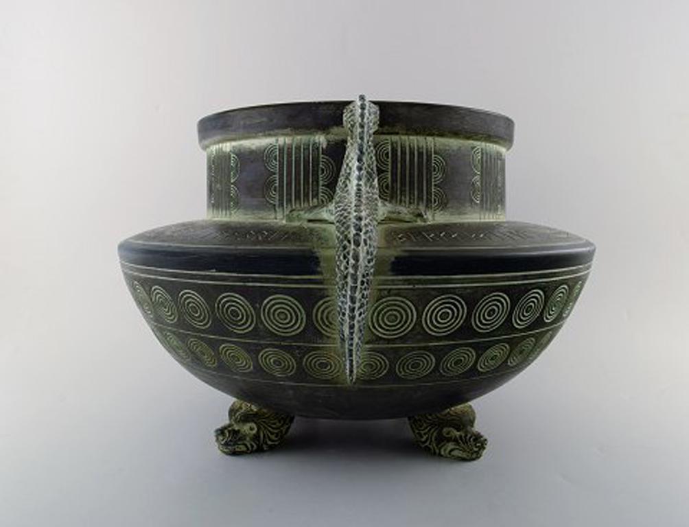 Michael Andersen. Very large and rare 'Old Nordic' tub / jar of cold painted terracotta with imitated bronze decoration, circa 1910.
Richly decorated with encircled pattern in the form of Midgard worms and rune stones: 'Reknar Lutbruk' (Regnar