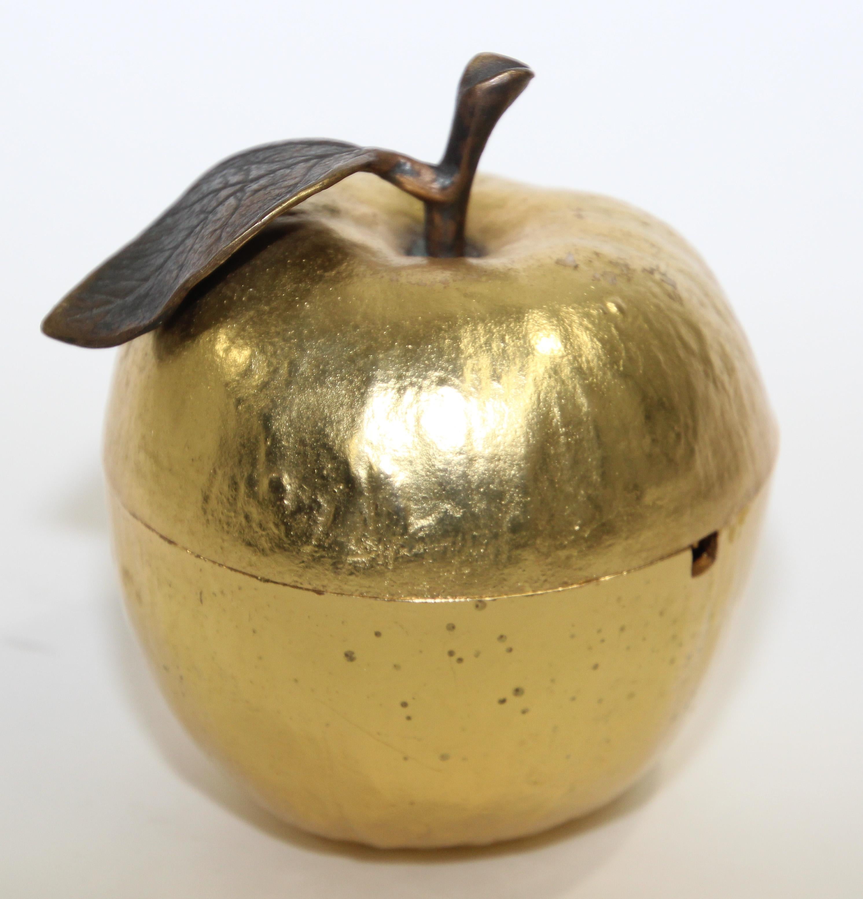 Gold-plated apple honey pot from Michael Aram.
Great decorative apple sculpture.
This apple lidded dish is gold plated with an oxidized bronze stem and enamel pigments. 
Measuring 3 1/2