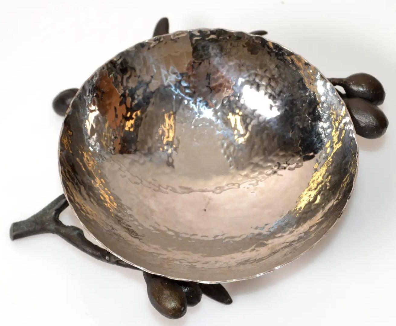 Michael Aram Olive Branch Silver Catch All Dish.Michael Aram Art Studio hand-hammered nickel plated bowl held up by a bronze olive tree branch. Elegant and great quality craftsmanship. Inscribed ARAM at the Base.The Olive Branch Collection takes its