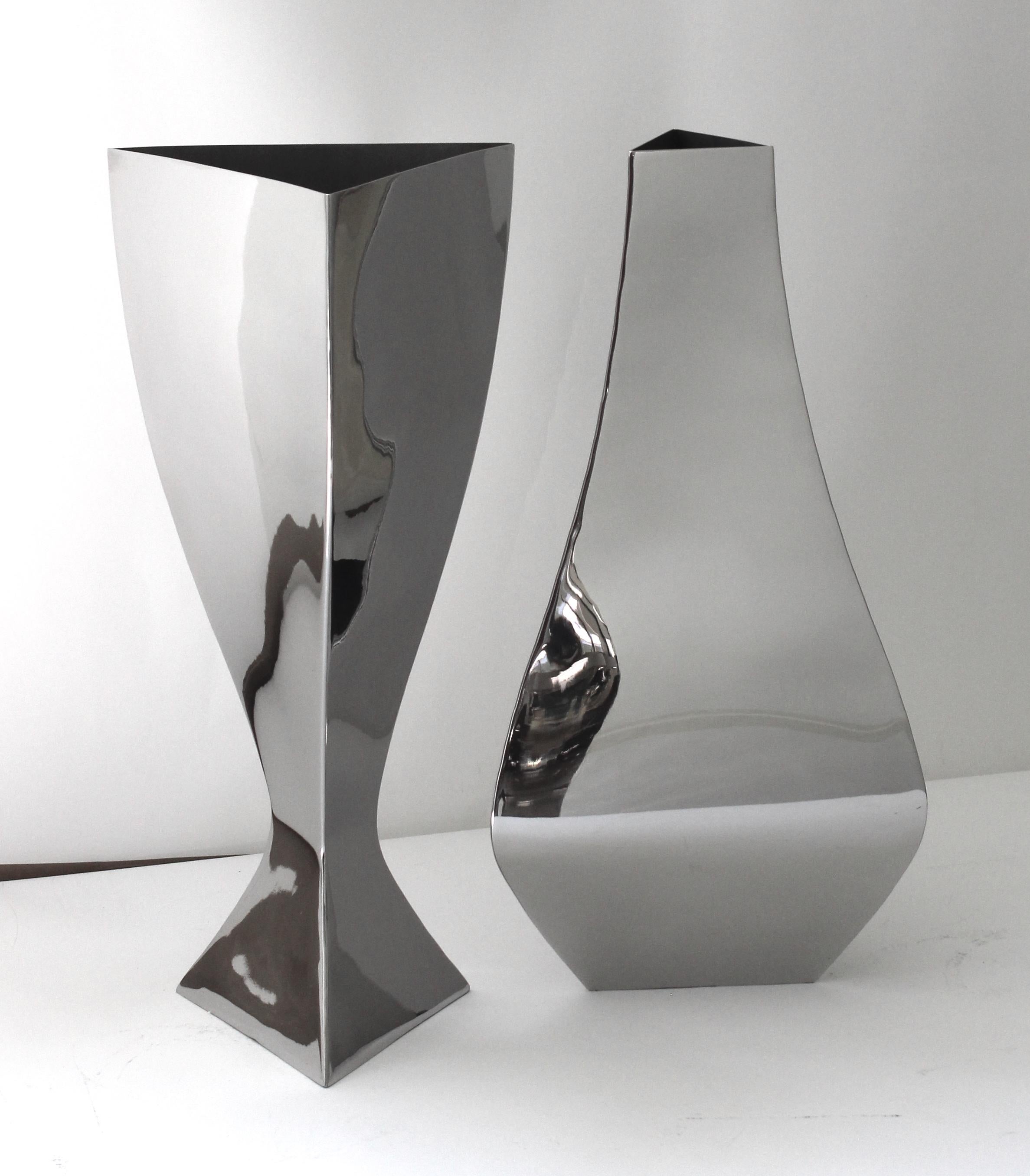 This stylish and chic two piece set of stainless steel vases will make a statment with their form and use of materials. 

Note: We have had the pieces professionally polished. 