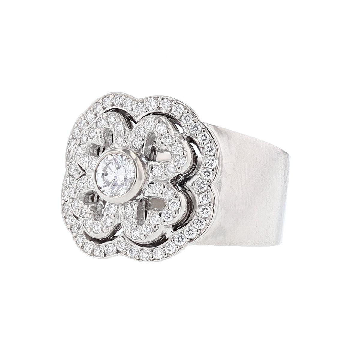 The Michael B. Petite Gardenia ring is made in 18K white gold and features a round cut diamond weighing 0.23cts in the center, bezel set. The ring also features 76 round cut diamonds weighing 0.37cts.
