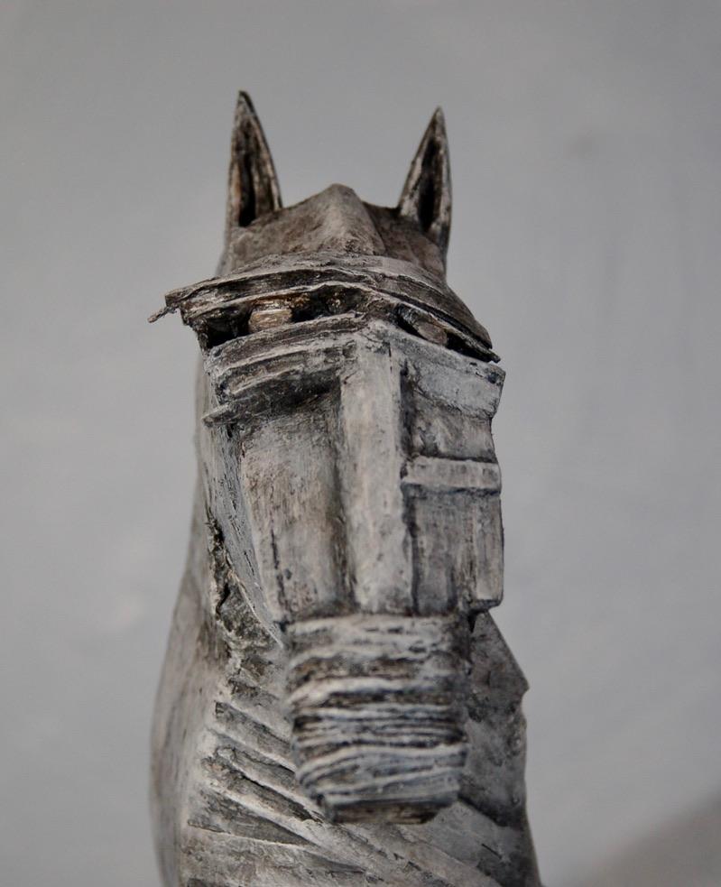 The Gray Stallion is an abstract Cubist sculpture of a horse. Made primarily from wooden sticks of various sizes and textures, The Gray Stallion is sealed with wax and putty, including on the string used for the nose, painted with acrylic paint and