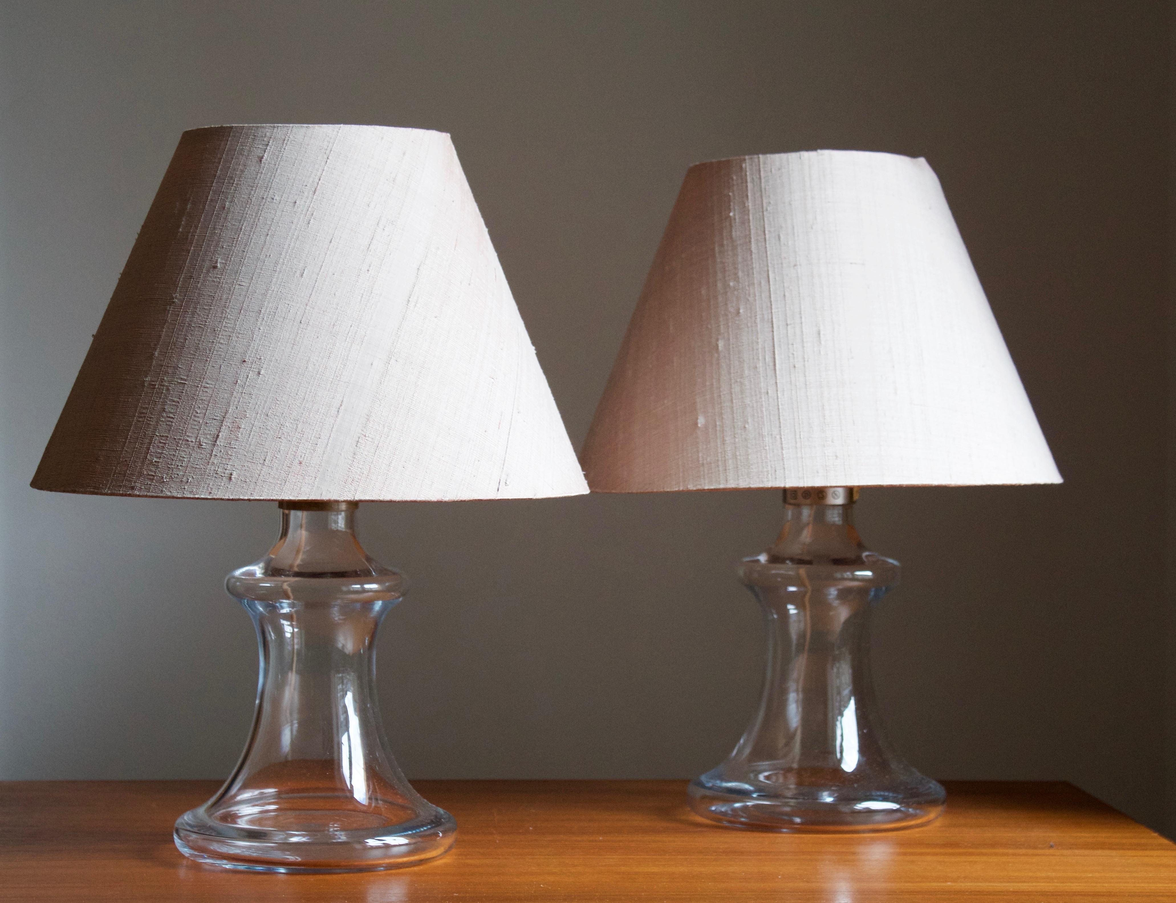 A pair of table lamps, designed by Michael Bang for Holmegaard Glasværk, 1978. Labeled. Original lampshades. Nickel-plated metal and blown glass.

Pair sourced in Germany and likely produced for export. 

Stated dimensions exclude lampshades. Sold