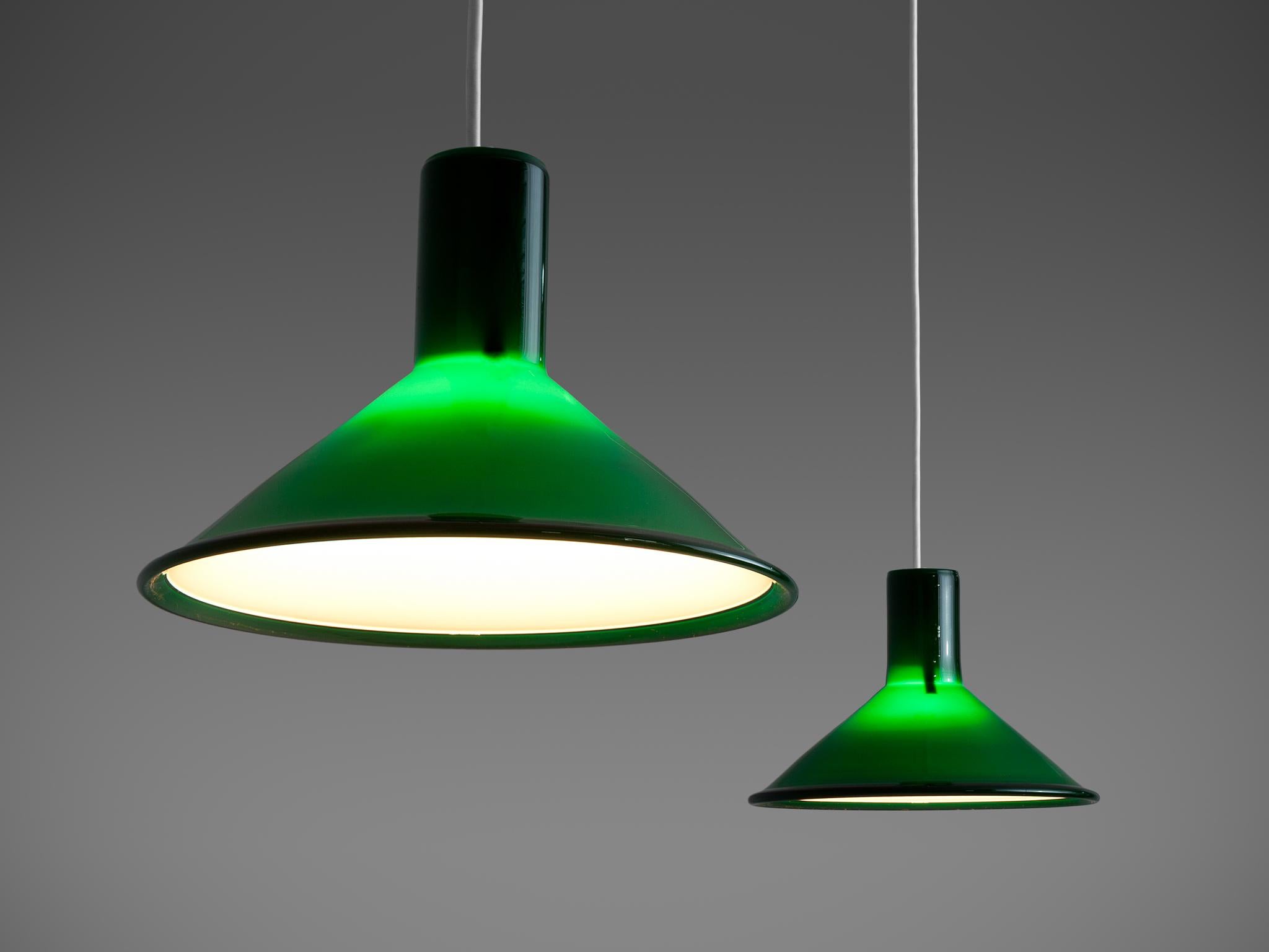 Michael Bang for Holmegaard, pair of pendant lights model 'Mini - P&T Pendel', green glass, Denmark, 1970s. 

These beautiful green glass pendants designed by Michael Bang for Holmegaard are made out of green glass and white inner casing. The deep