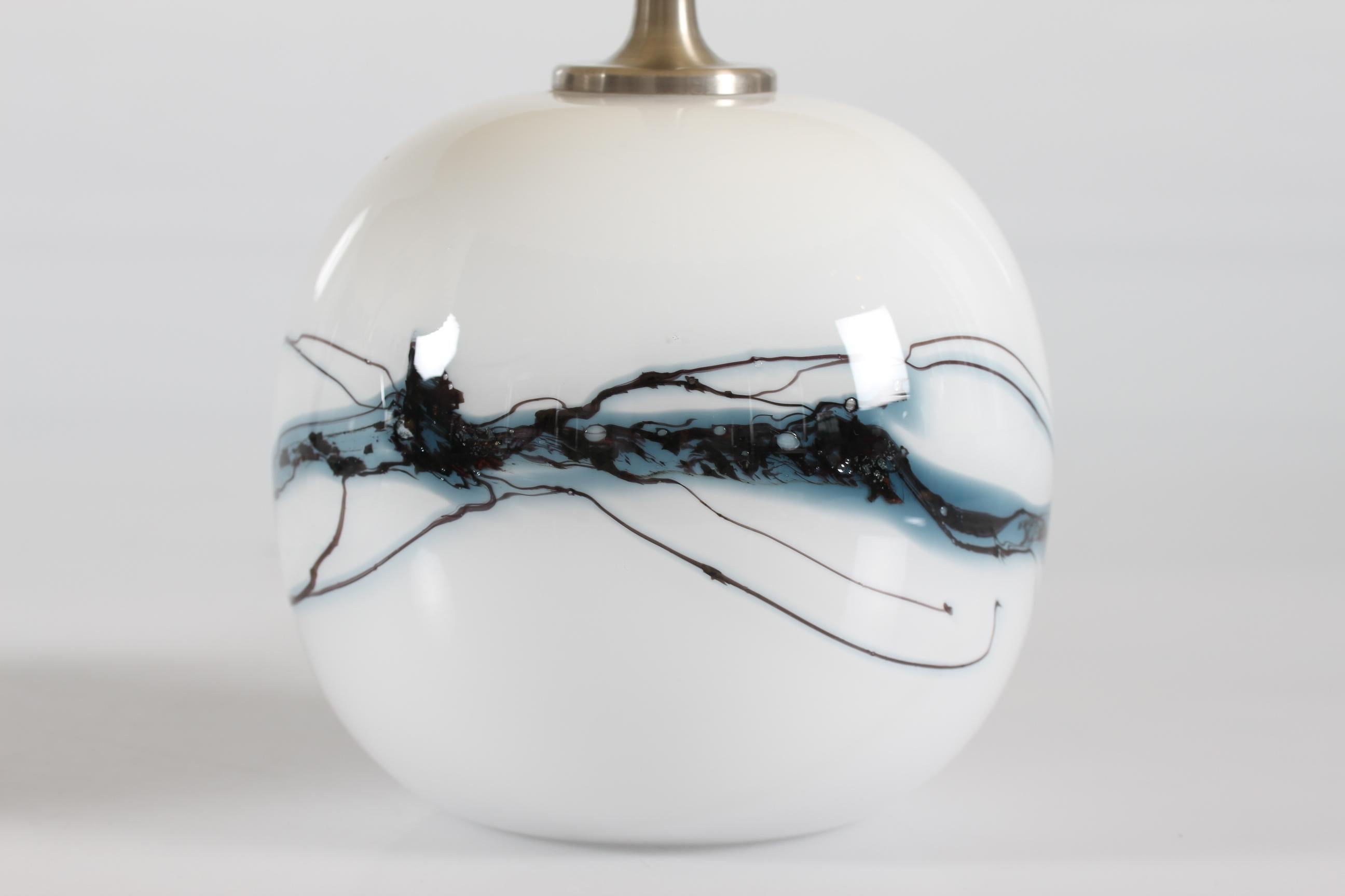 A pair of sakura small ball-shaped table lamps designed by Michael Bang for Holmegaard Glass-works.
Manufactured in Denmark 1980´s

The lamps are made of mouth-blown white opaline glass with an abstract decoration in blue and black colors.