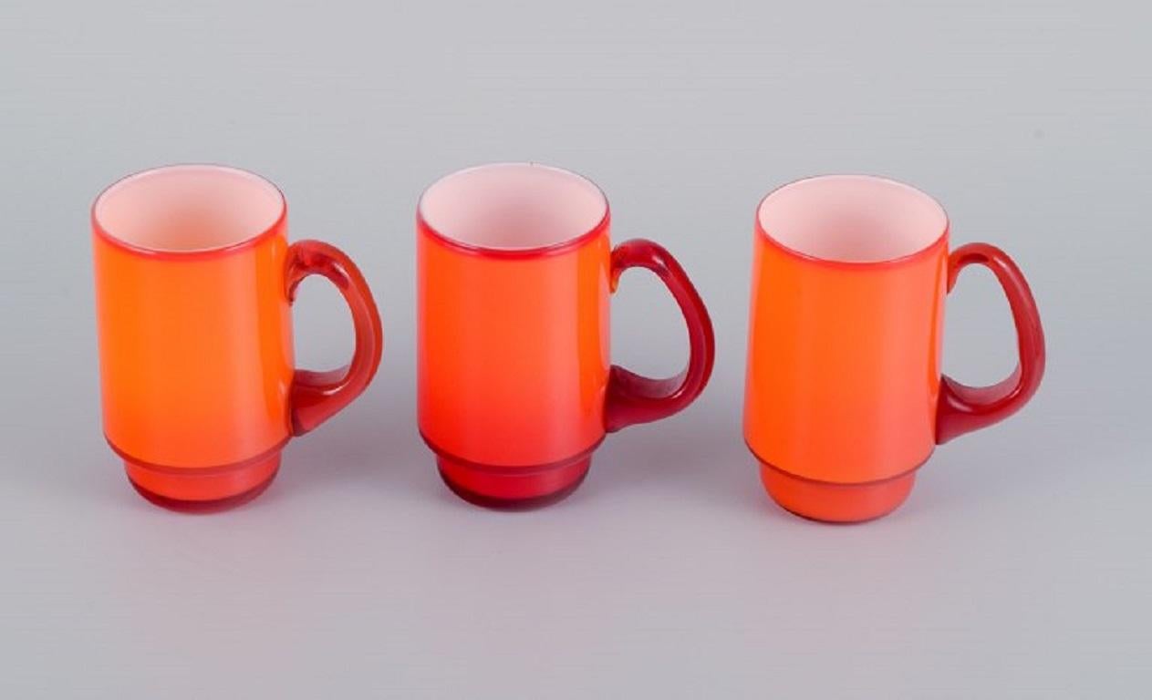 Michael Bang for Holmegaard.
Three mugs in orange and white art glass.
1960s.
In perfect condition.
Dimensions: W 9.0 (with handle) x H 10.5 cm.