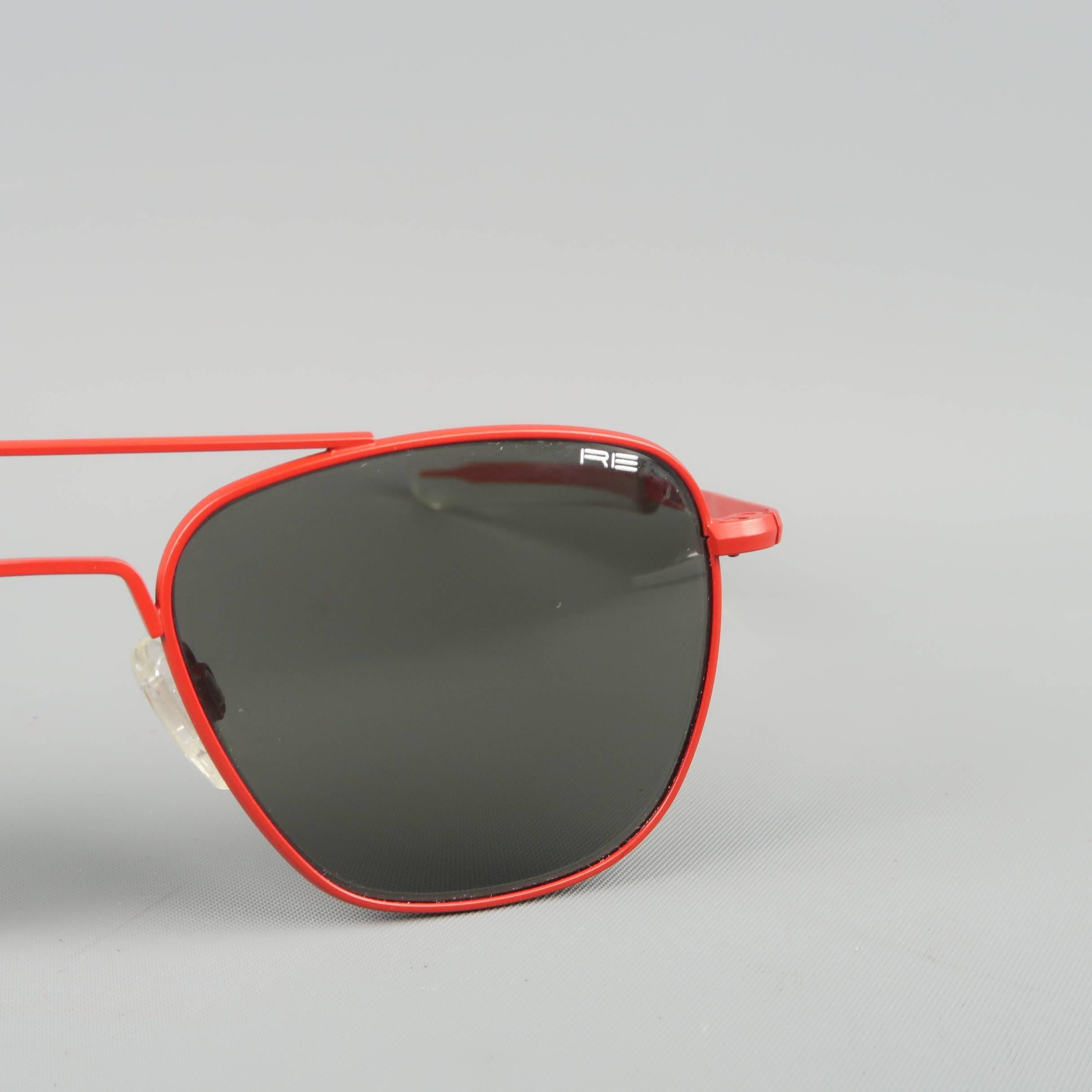 MICHAEL BASTIAN for Randolph Engineering sunglasses come in red matte coated metal in an aviator style with angular black lenses and clear arm ends. Minor Wear. Made in USA.
 
Good Pre-Owned Condition.
Marked: 140mm  
 
Measurements:
 
Width: 12