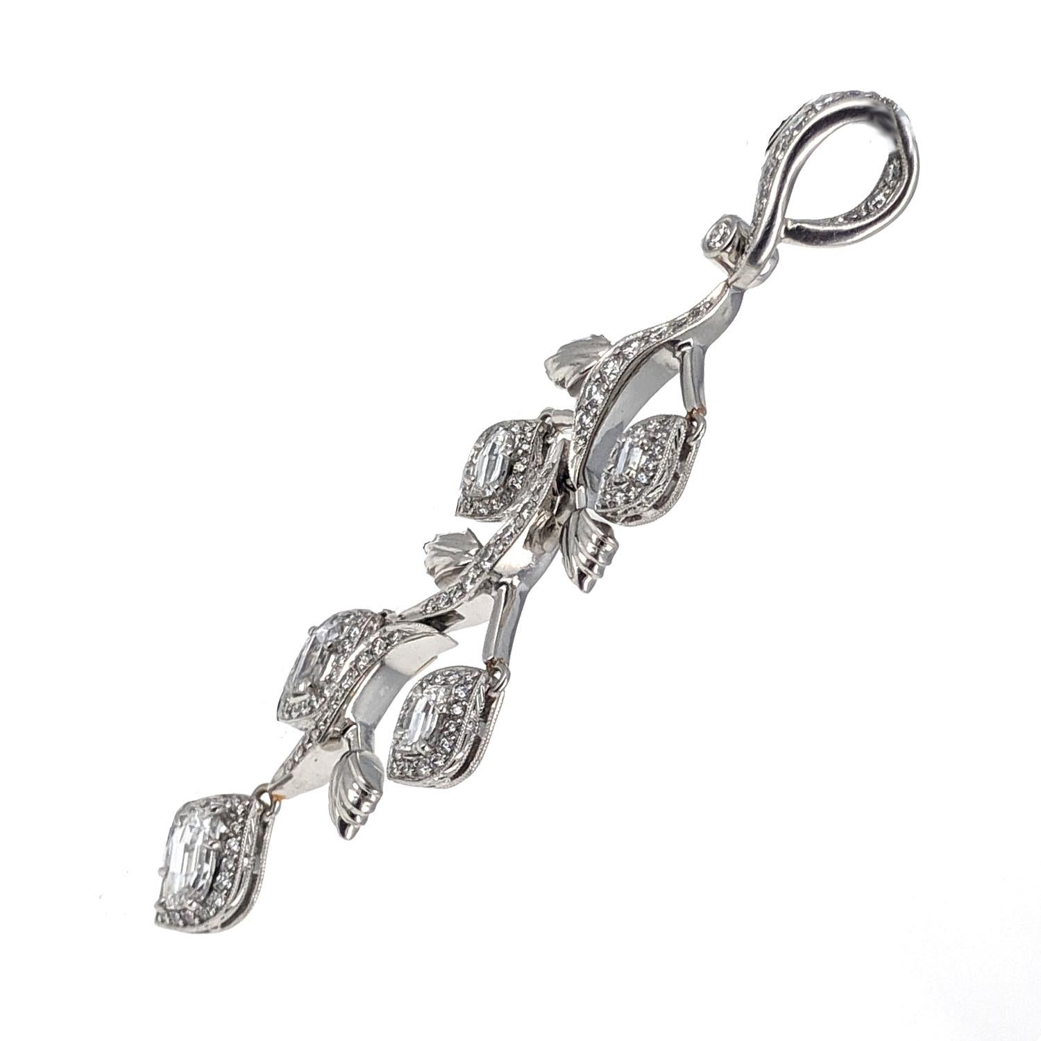 This tapering moveable vine pendant suspends little leaf pendants that are set with larger fancy-shaped diamonds in addition to the small round diamond pave. There is an estimated 4 carats of diamonds all set into the millegrain 18 karat white gold
