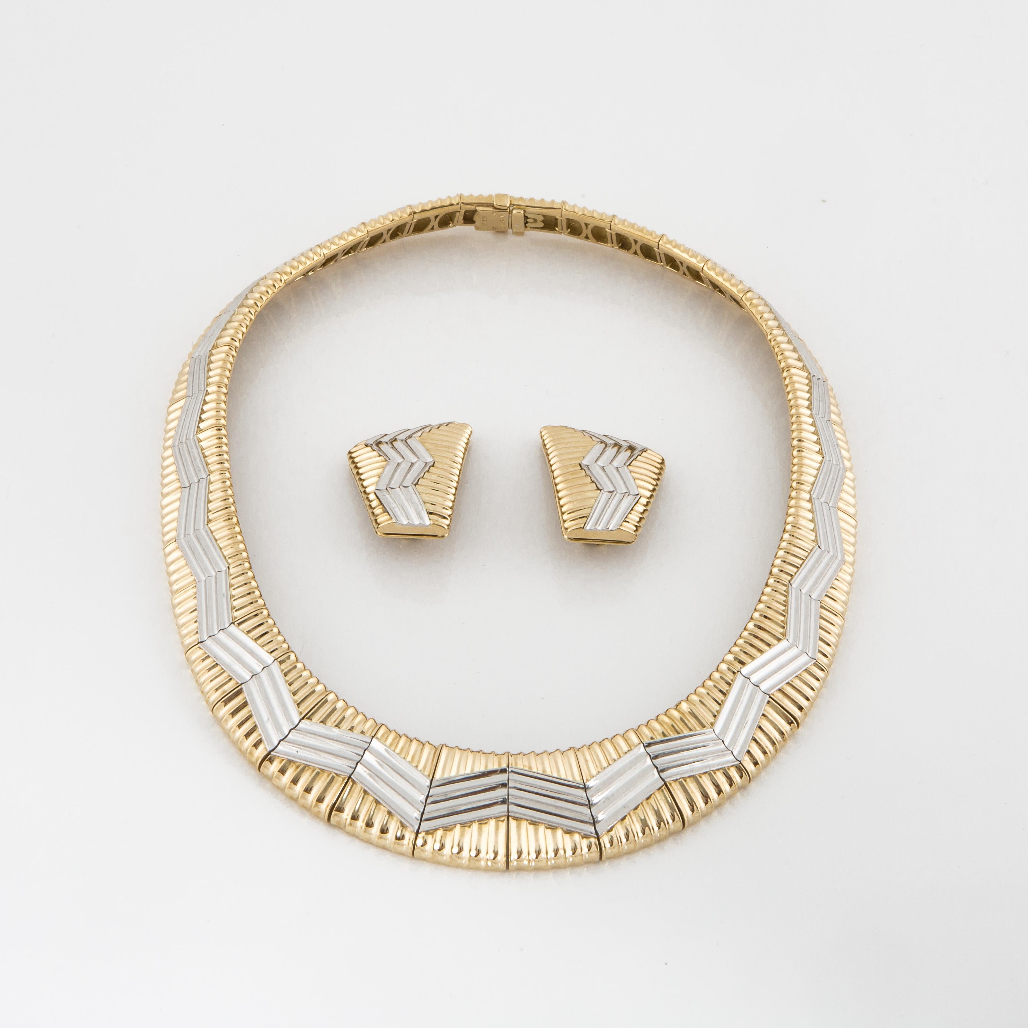 18K yellow gold and platinum necklace with matching earrings by Michael Bondanza.  Features a zig zag pattern on top in platinum and set into yellow gold.  Necklace measures 17 inches long and 3/4 inches at the widest point.  The earrings are clip