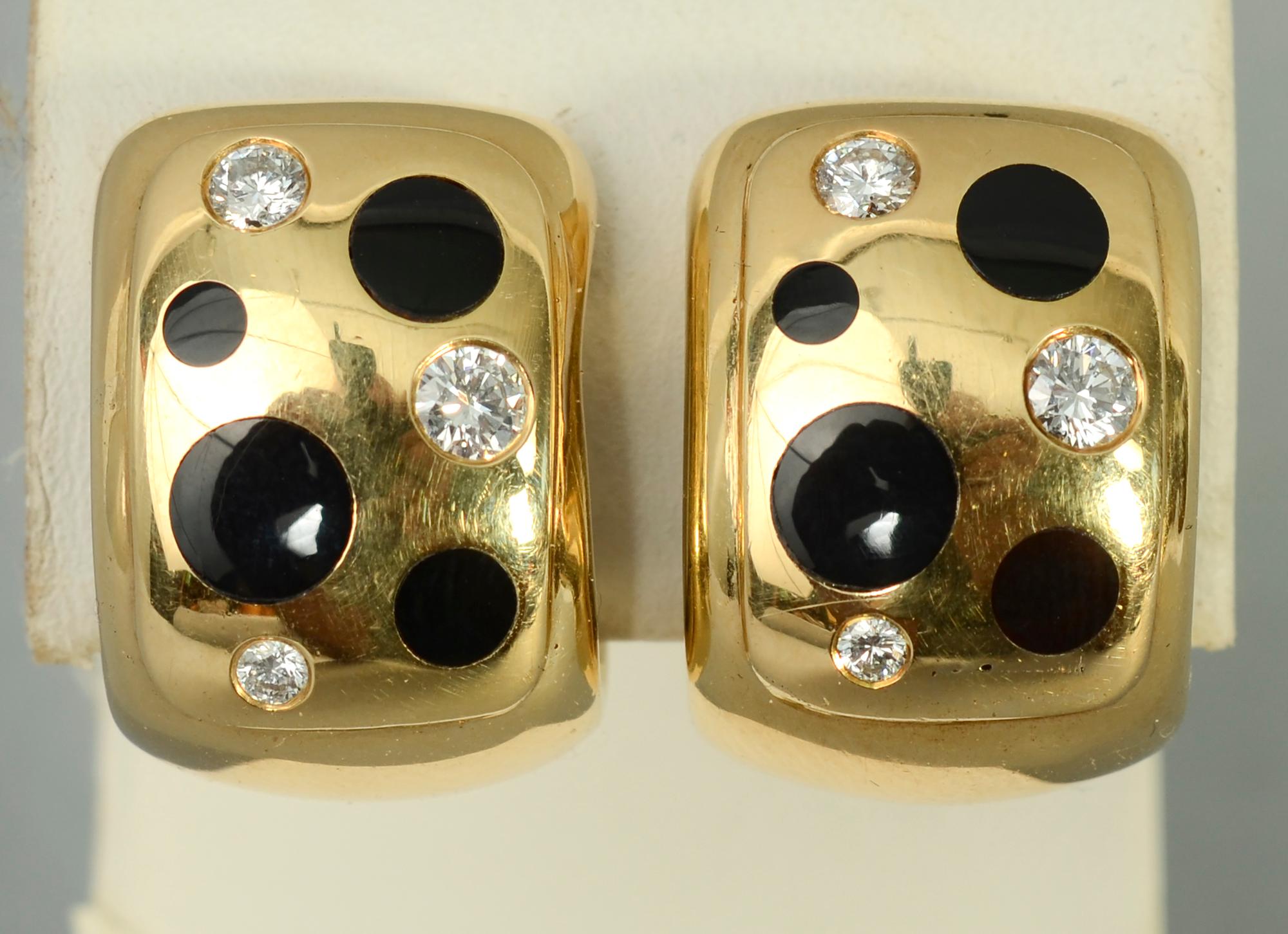 Lively earrings by Michael Bondanza with polka dots of onyx and diamonds. Each of the  four round onyx stones is a different size. Three diamonds have a total  weight of approximately .4  carats. Backs are clips.