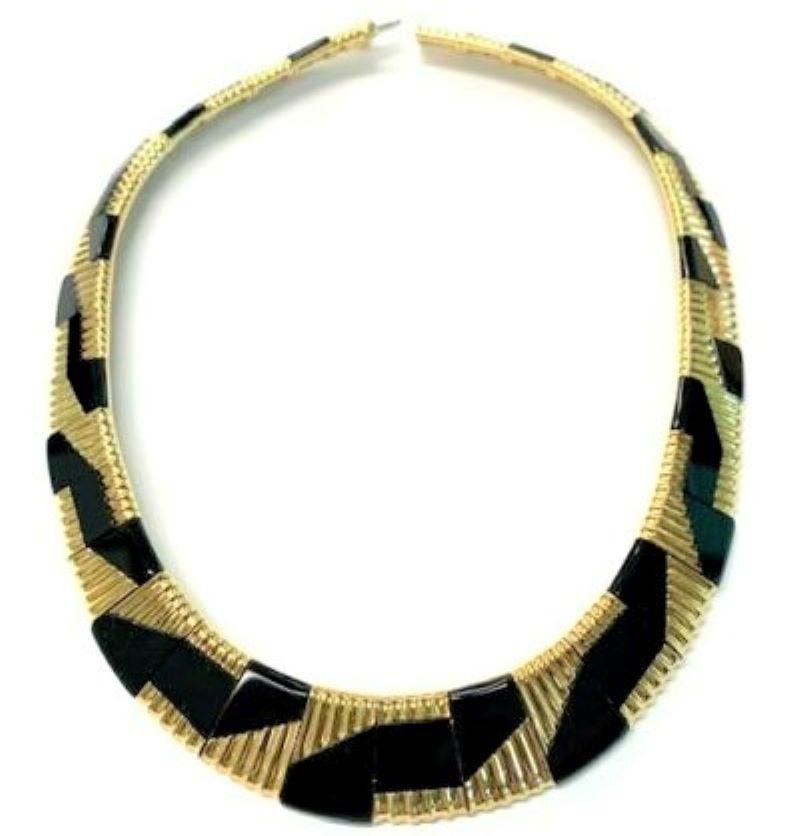 This major work by the esteemed jewelry designer Michael Bondanza, is crafted from 18k gold and polished slabs of black onyx crafted  in a very Avante-Garde design. With every link vertically fluted and with all links inlaid with onyx in a repeating
