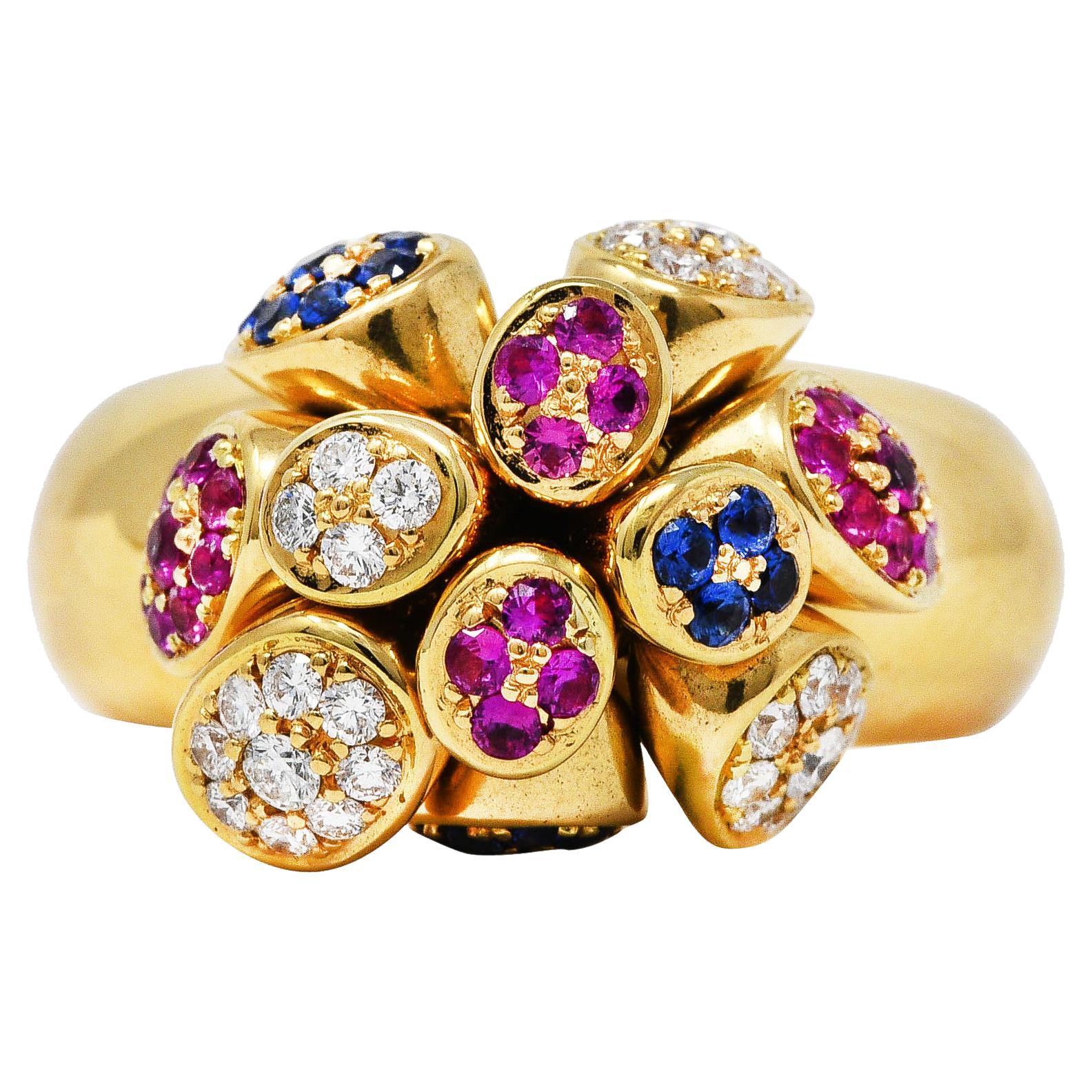 Puffed band ring is topped by conical forms that articulate and 