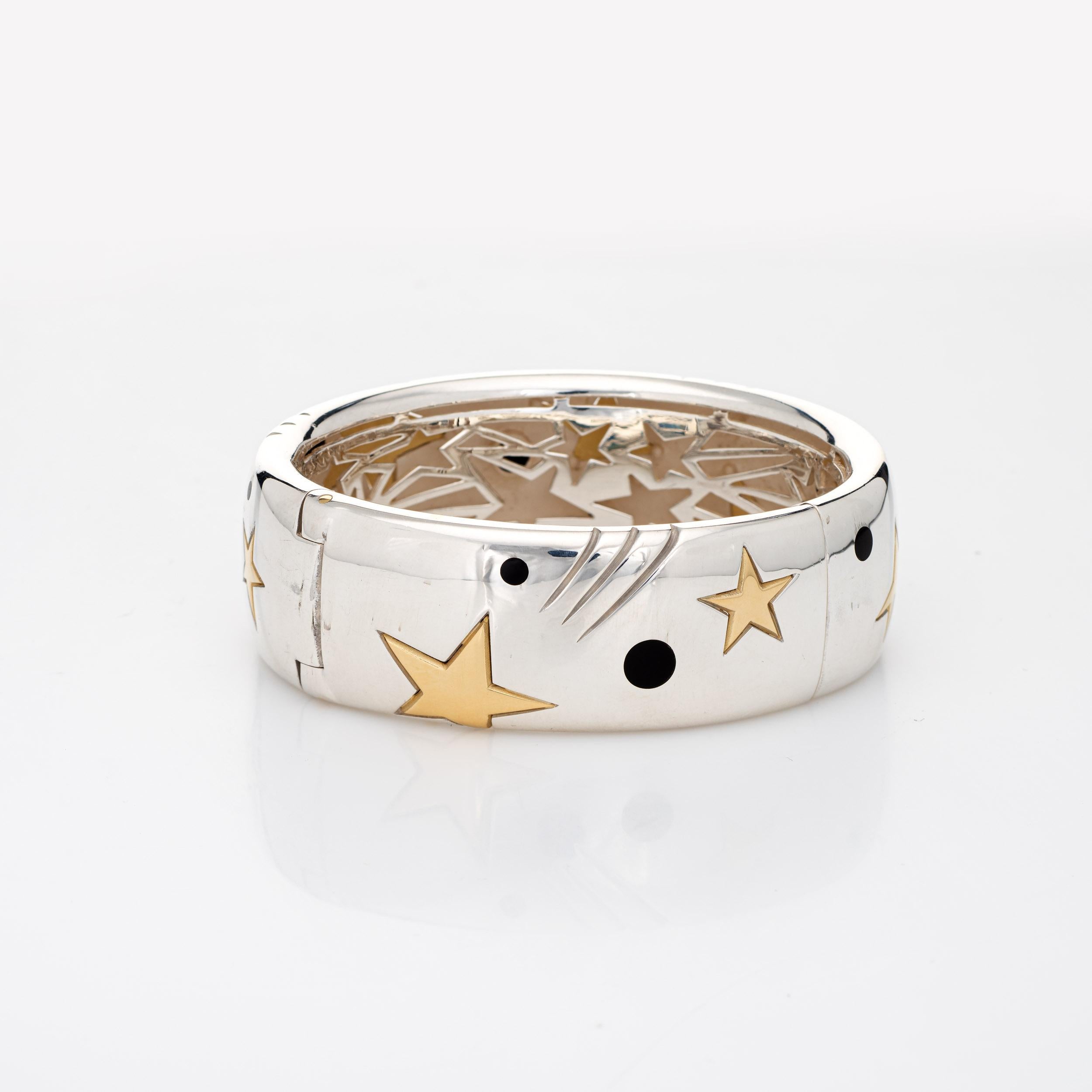Stylish Michael Bondanza star bracelet crafted in sterling silver & 18 karat yellow gold (circa 2000s). 

The bangle bracelet features a star pattern rendered in 18k yellow gold and makes a great statement on the wrist. Michael Bondanza is a gifted