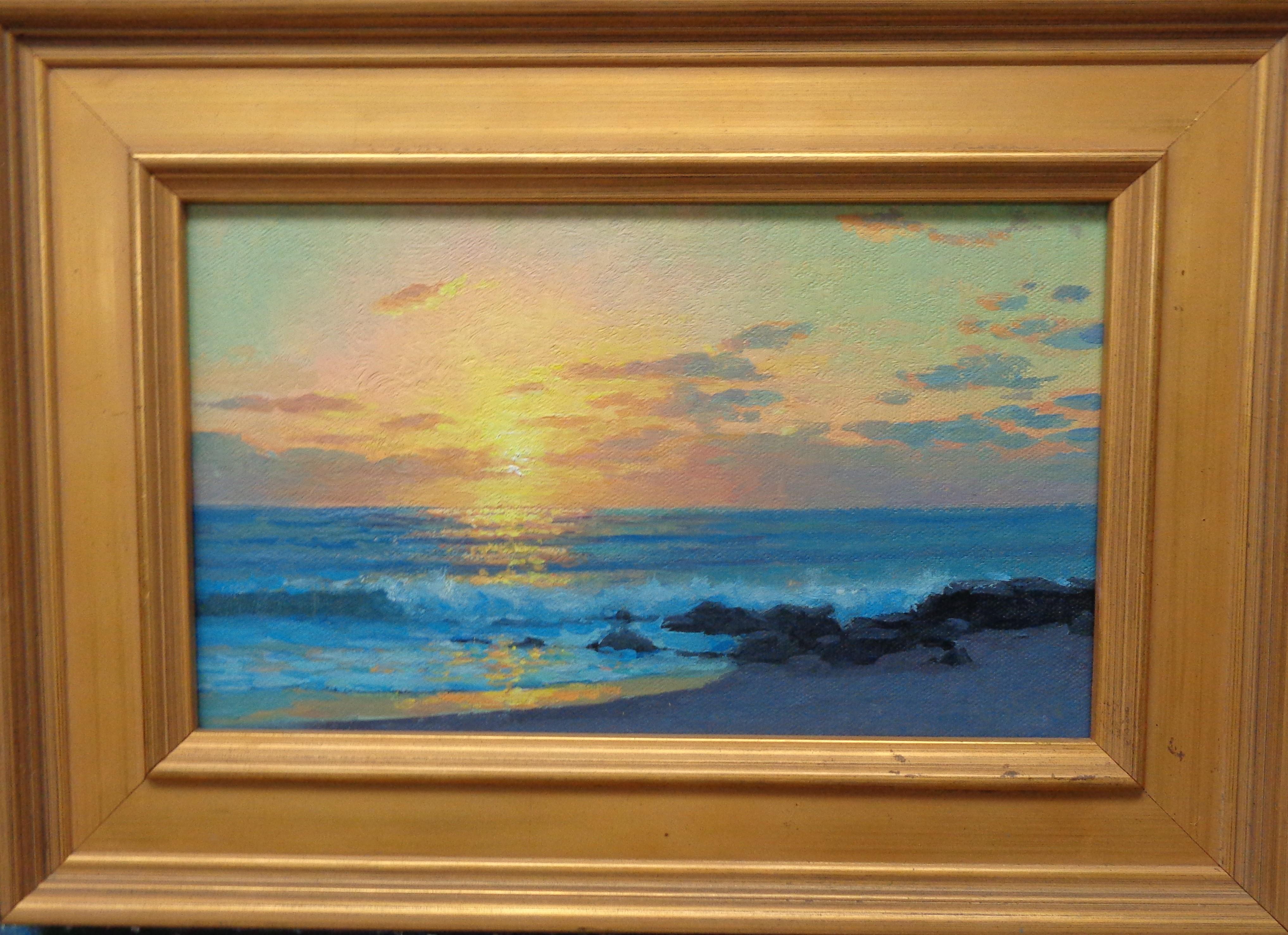 Dawn By The Sea is an oil painting on canvas by award winning contemporary artist Michael Budden that showcases a beautiful sunrise at the beach.  This painting is new and the image measures 6.25 x 10.25 unframed. The frame shows age with some