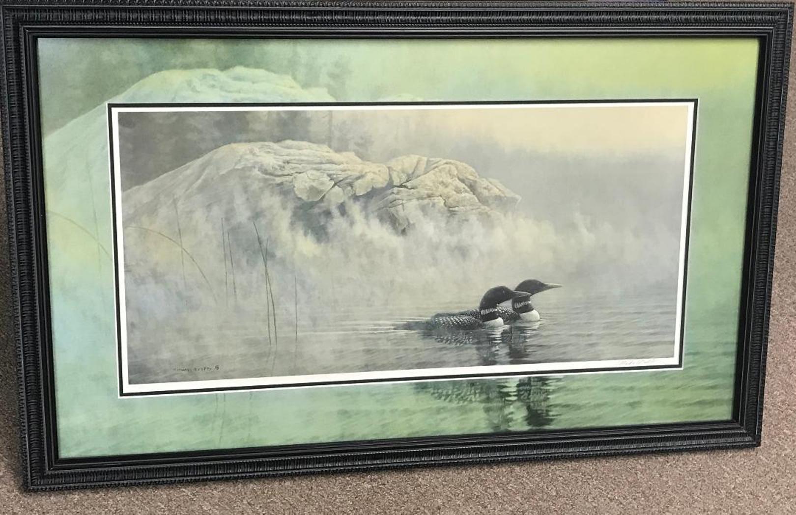 A limited edition offset print by award winning contemporary artist Michael Budden that showcases a pair of loons in their natural environment created in an impressionistic realism style housed in a printed mat to match framed under museum image