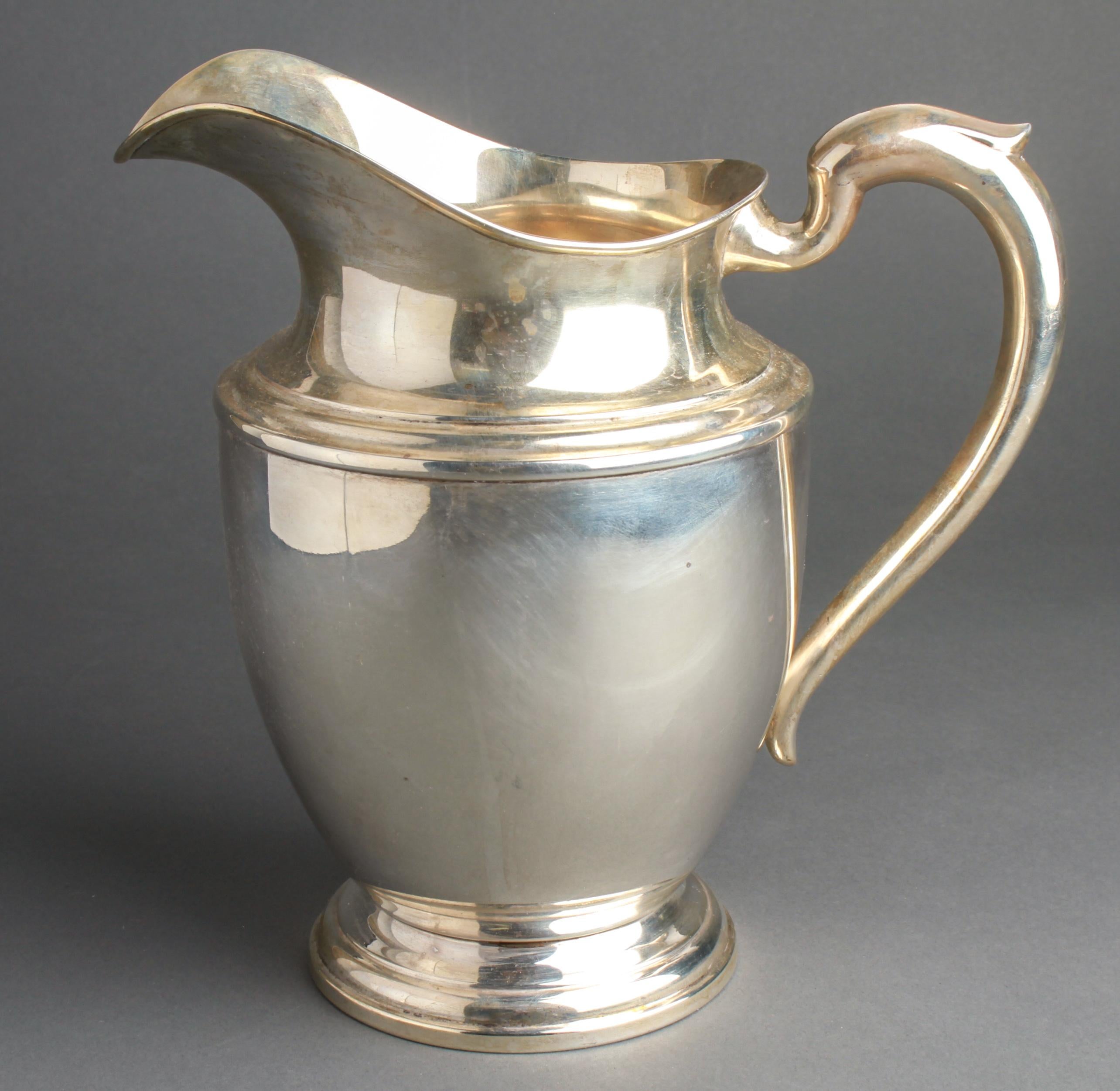 American sterling silver water pitcher by Michael C. Fina Co. Inc. from New York, NY, founded in 1935. The piece is in great vintage condition with age-appropriate wear and has a maker's mark and is marked 