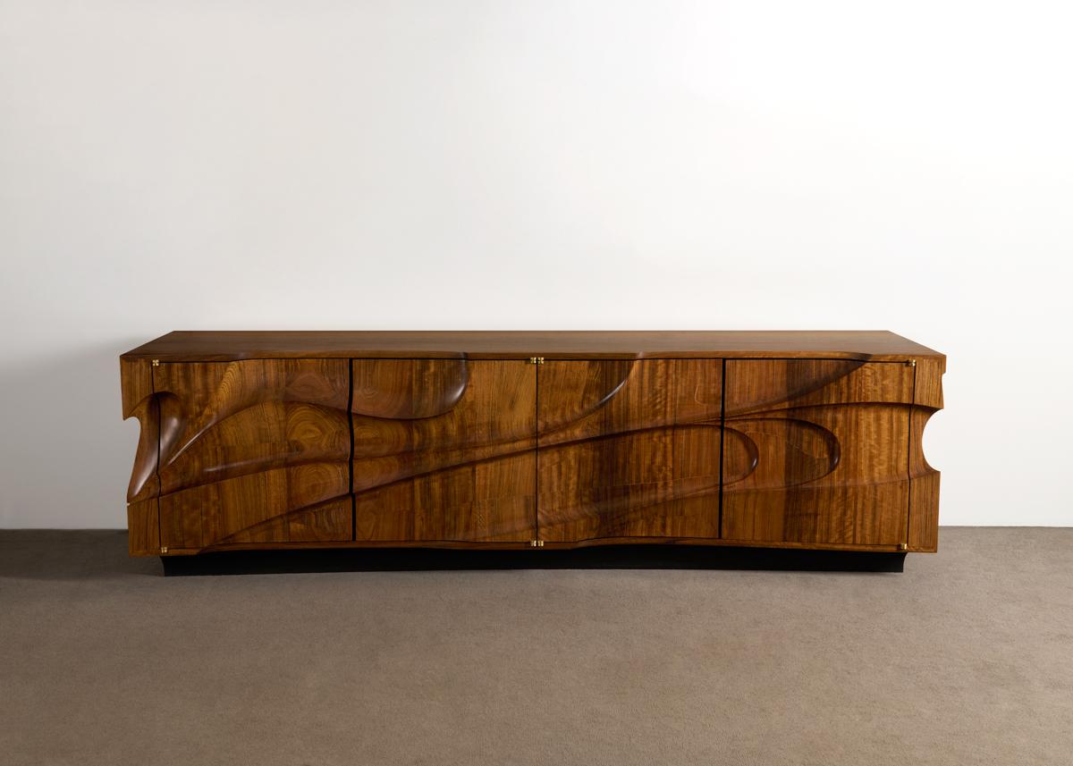 A sculptural cabinet carved in solid Mozambique. Coffey debuted this style of carving at Directional Furniture in New York, in 1972. In the 90’s he revived it, giving it the name, 