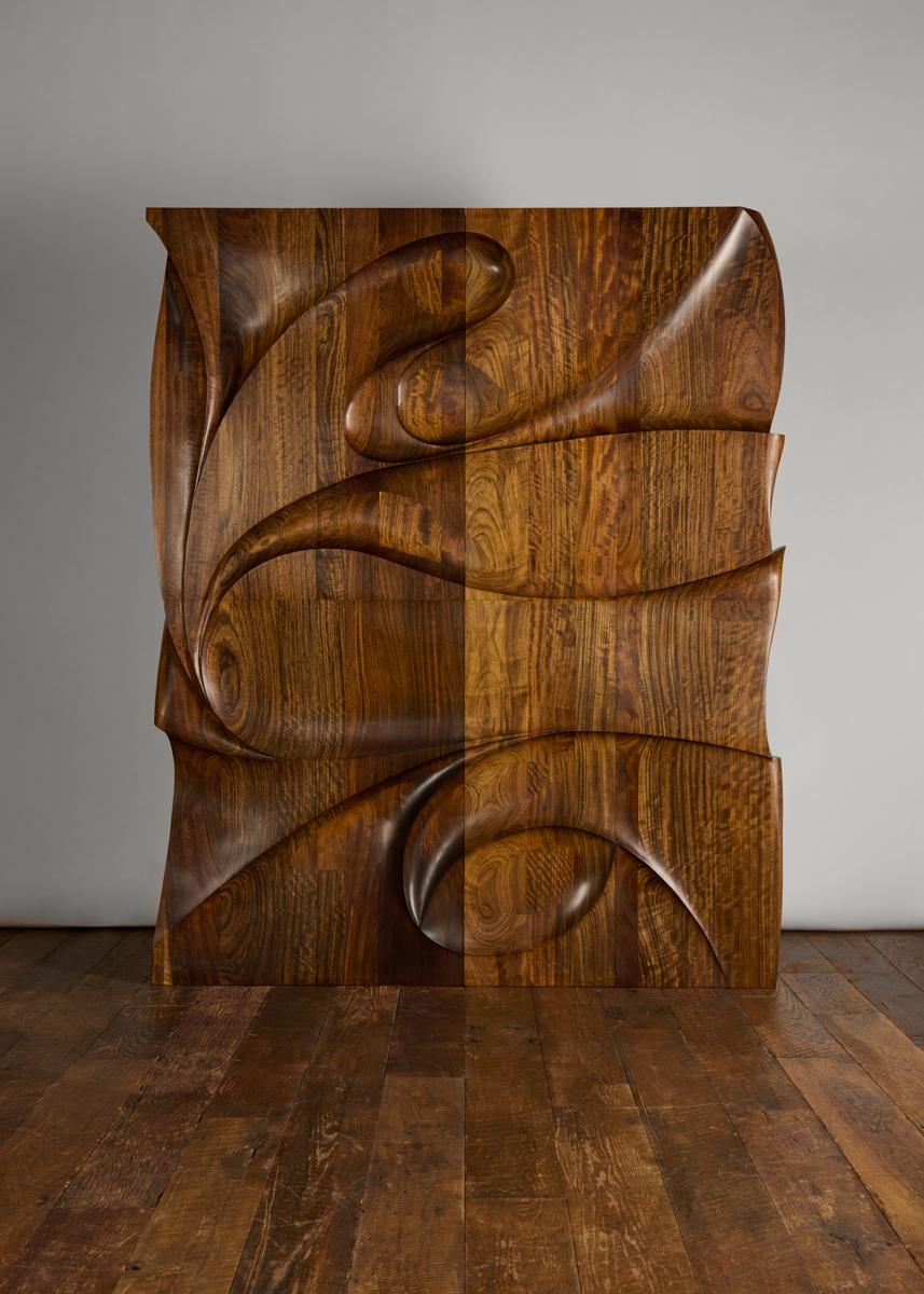 Sculpted from walnut, Galaxy II is an exceptional wall-mounted sculpture that exhibits the skill of artist and master woodworker Michael Coffey. It is yet another extraordinary variation on the “geolithic carving” Coffey debuted in 1972 at