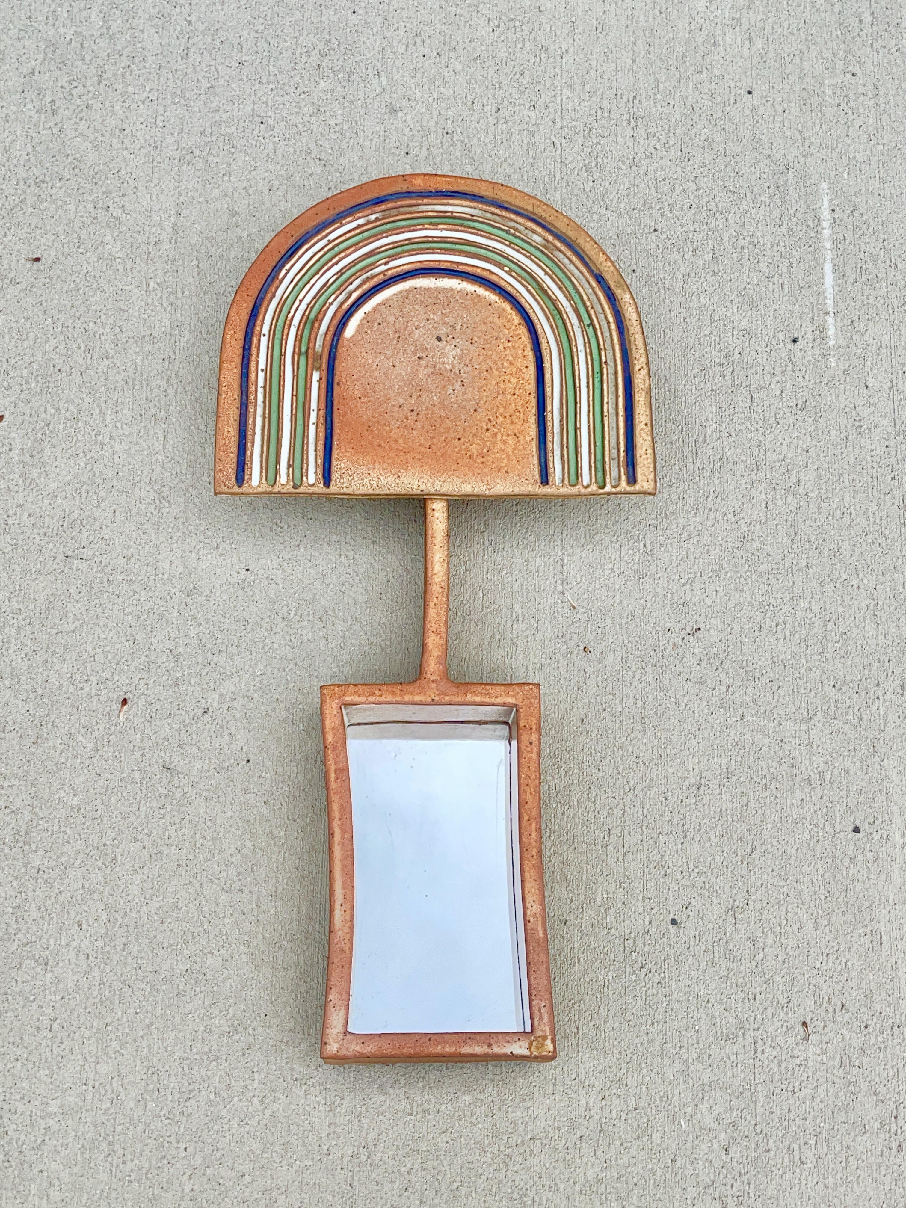 Sculptural wall mounted shadow box mirror in glazed ceramic stoneware by artist Michael Cohen, USA, circa 1970. Artist's studio mark on side of slab. Stamped on backside as well as on cork backing.

Michael Cohen had an artistic upbringing, and was
