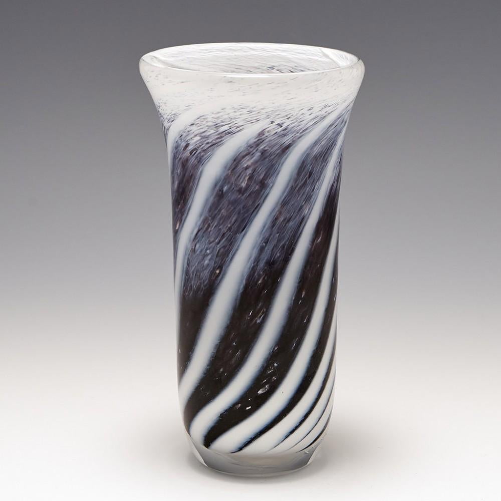 Heading : Michael Crane Signed Studio Glass Vase
Date : 2003
Origin : Cullompton, England
Bowl Features : Extended bell-shaped bowl with twisting spiral colours rising from the base in white, charcoal grey and amethyst cased in clear
Marks :