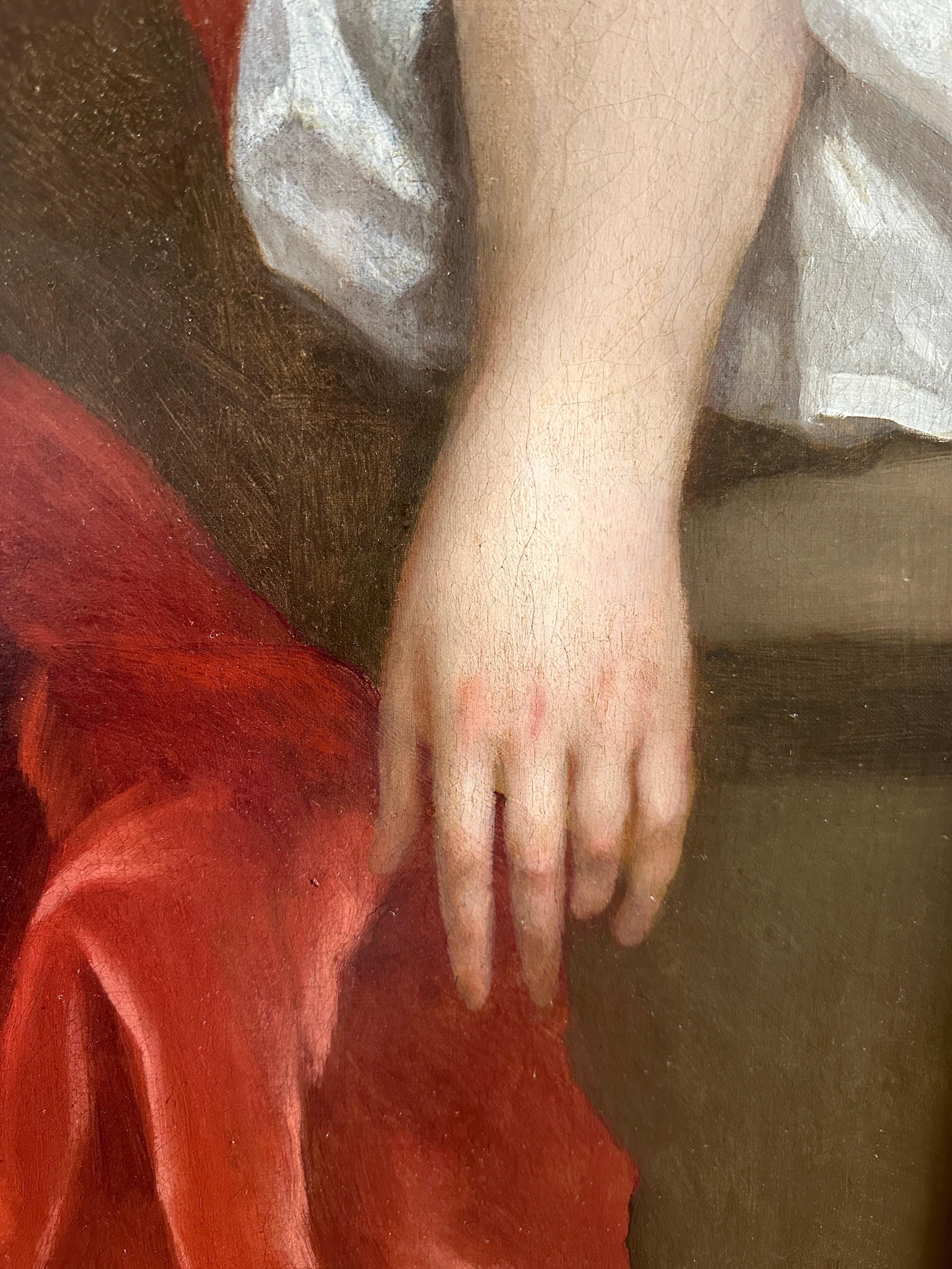 Portrait d'une dame de trois-quarts, assise dans un intérieur, vêtue d'une robe de soie rouge drapée d'une ceinture de soie rose, un oiseau exotique perché sur sa main et un bras reposant sur un socle en pierre,  sa jeune fille, vêtue d'une robe de
