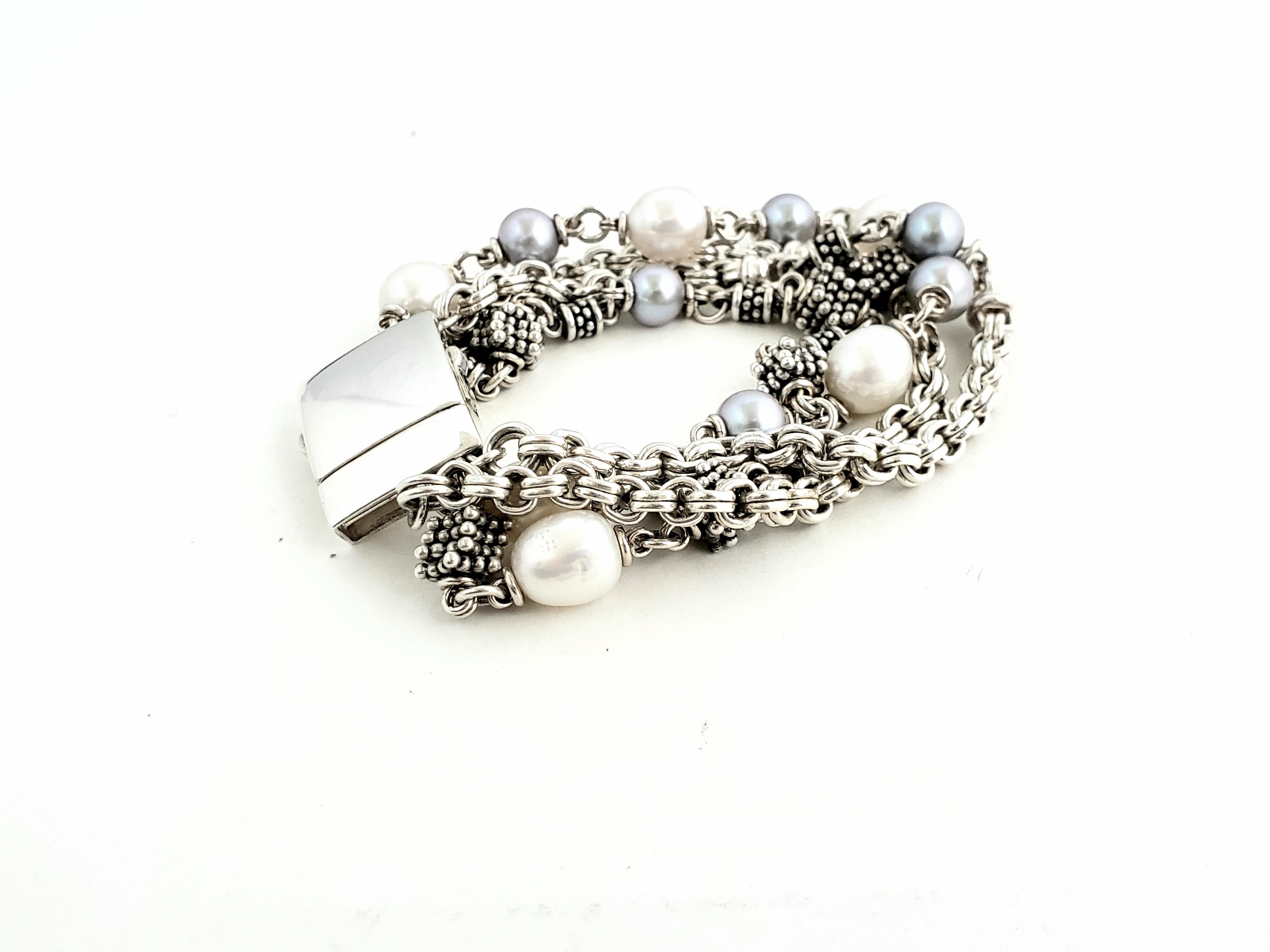 Michael Dawkins Sterling Silver and Pearl MultiStrand Bracelet

Beautiful Michael Dawkins Sterling Silver and white & grey pearl bracelet, The bracelet features four strands with rondel beads, sterling clusters, and gray and white cultured pearls.