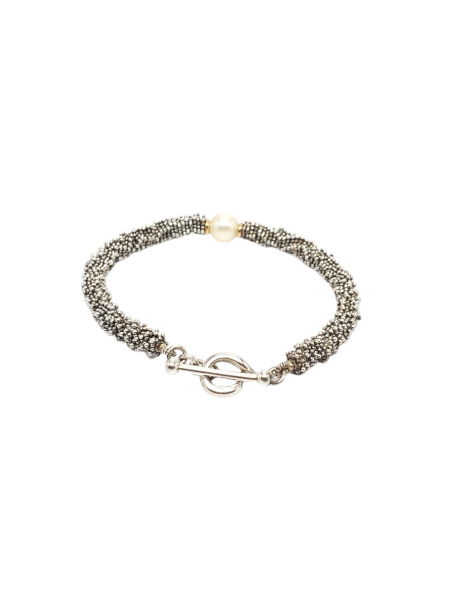 Michael Dawkins Sterling Silver Beaded Bracelet-

This classic Michael Dawkins beaded pearl bracelet is crafted in sterling silver & features a toggle clasp.

Size: 7 in.

Stamped: Michael Dawkins 925.

Weight: 11.8 dwt./ 18.4 gr.

Very good
