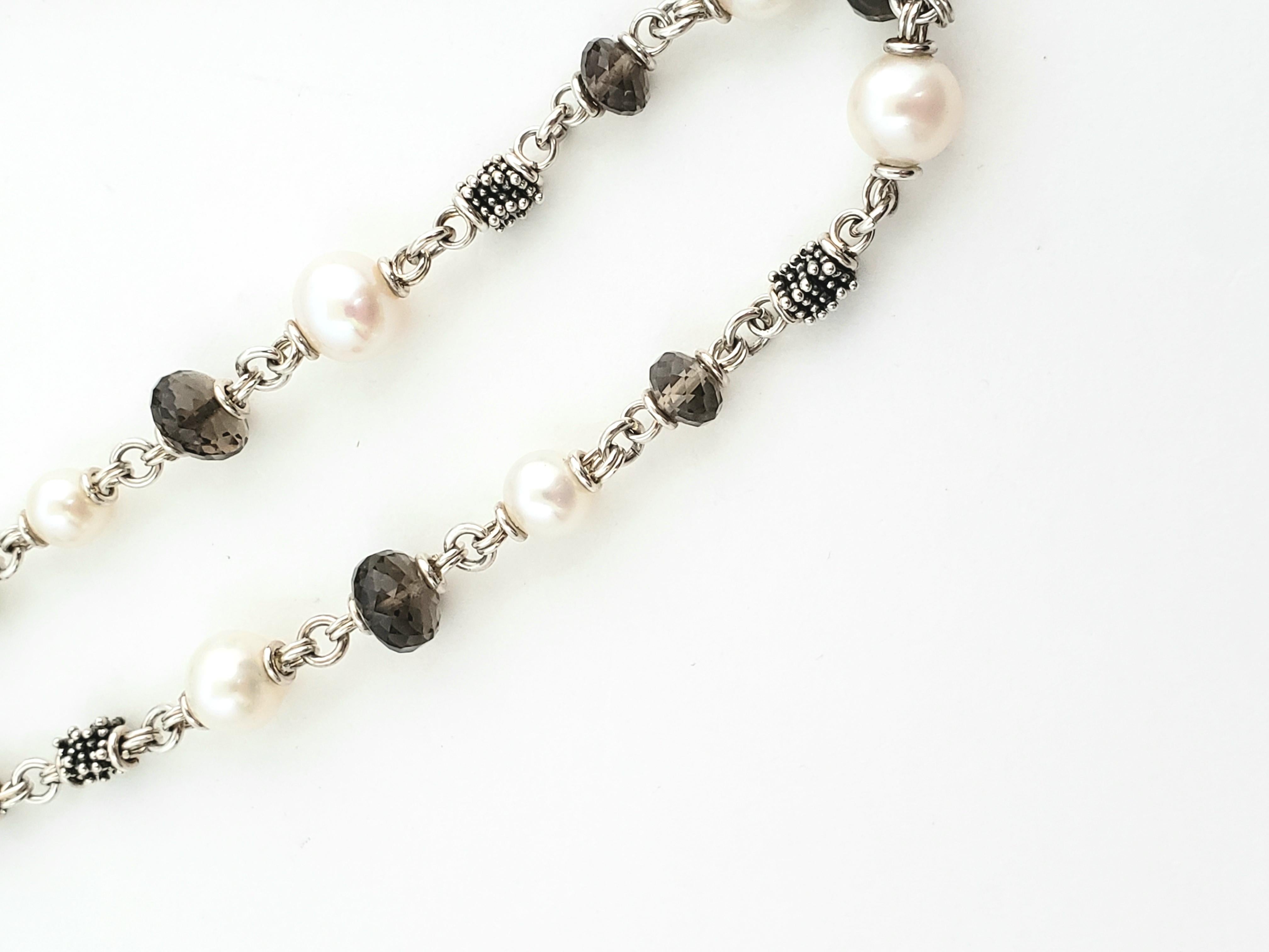 Michael Dawkins Sterling Silver Pearls and Smokey Topaz Necklace

This is a beautiful and authentic Michael Dawkins silver necklace with pearls and smokey topaz quartz rondelles. 

Measurements:  36 inches length.  Pearls 8.5mm.  Topaz 6mm.

Weight: