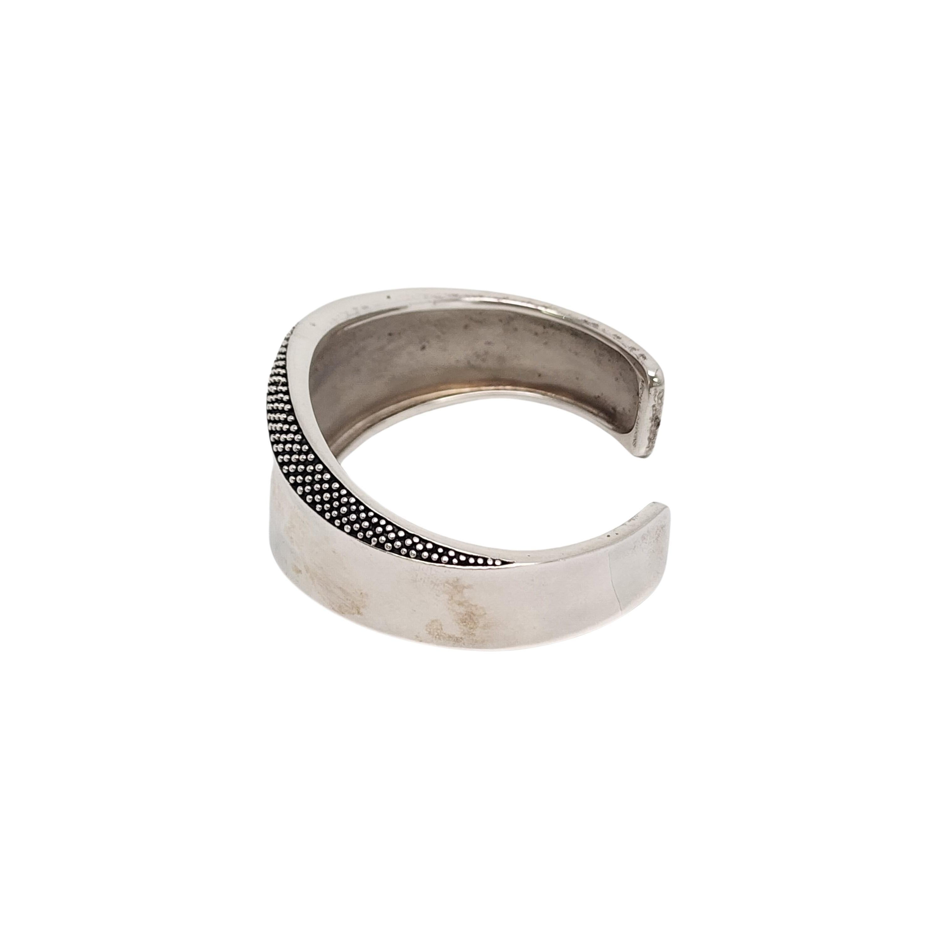 Sterling silver bead granulation cuff bracelet by Michael Dawkins.

Sculptured wave design cuff bracelet featuring bead granulation accents.

Measures approx 7