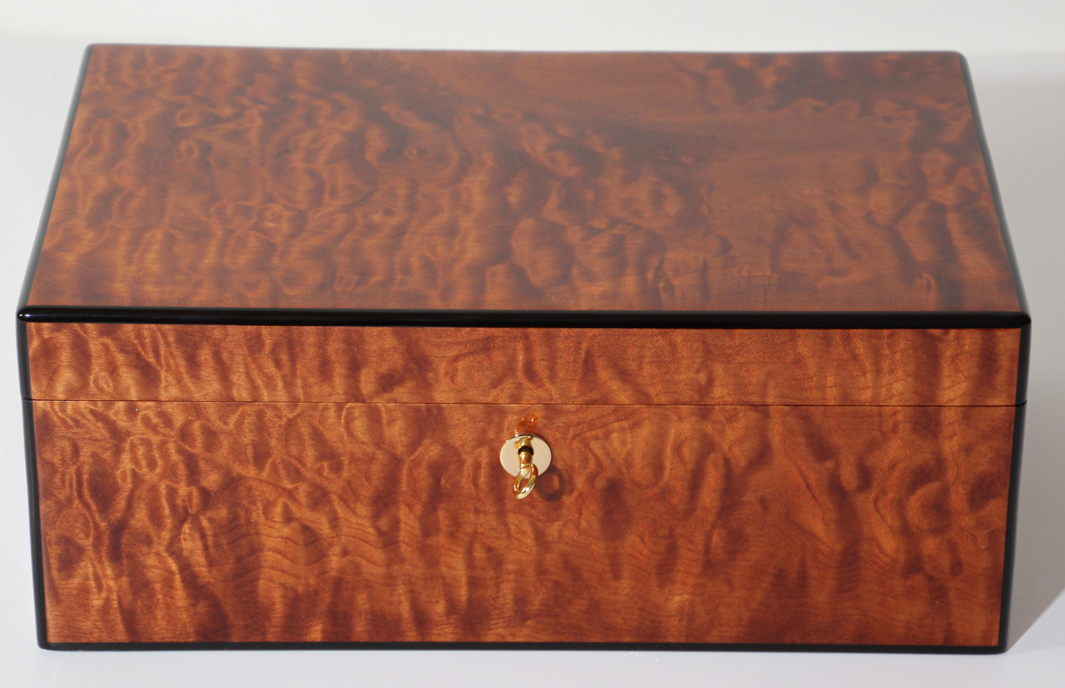 This superb stylish humidor is fabricated in burl wood veneers and can store up to about 125-150 cigars. 
Michael Dixon custom humidor built from the finest grade of domestic and imported Marbled Maple Cedar hardwood and veneers, and all wood