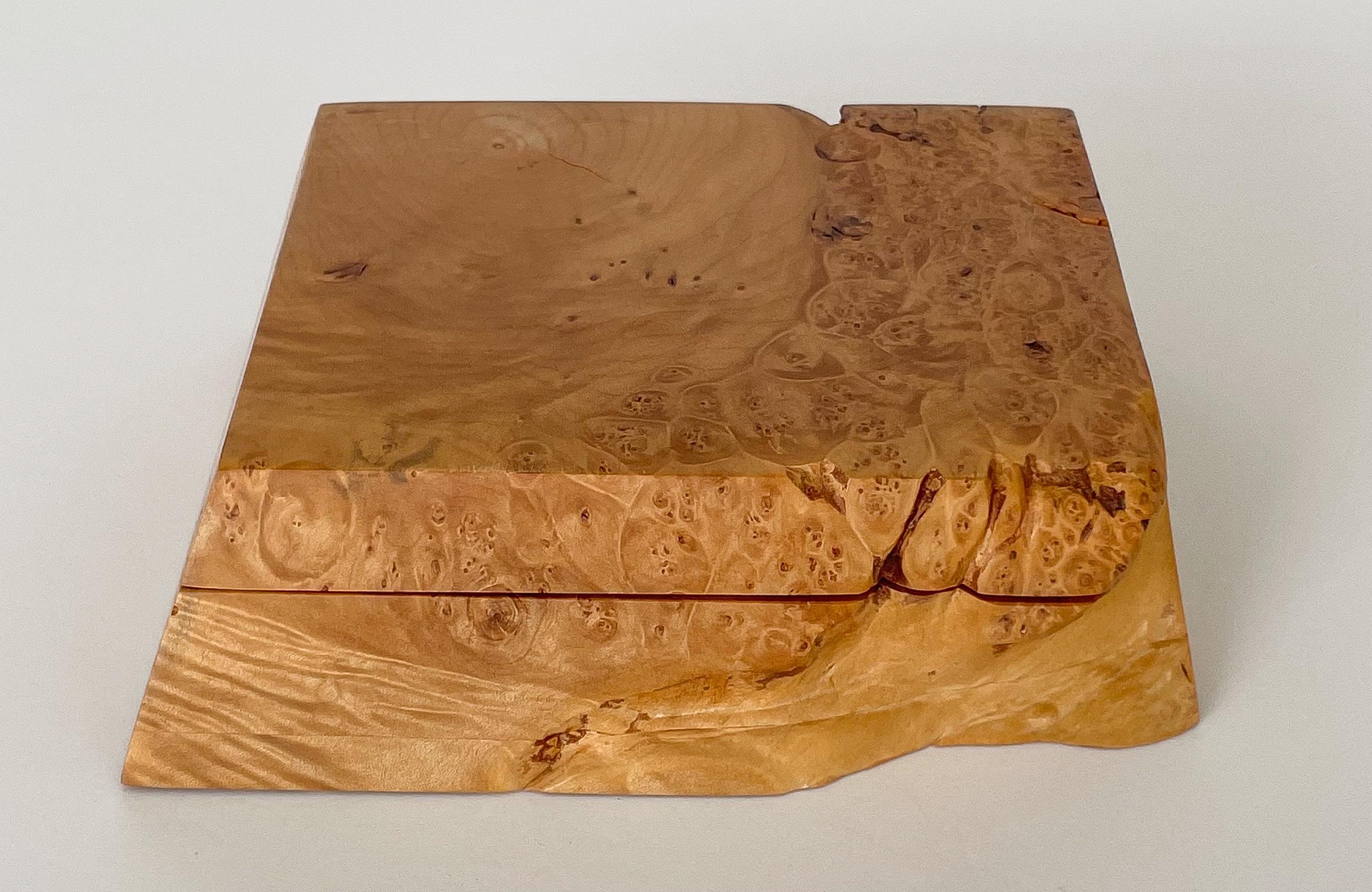 Michael Elkan studio craft carved burl wood box, circa 1980s. This trinket / jewelry box is handcrafted from a single piece of solid burl wood. Brass hinged lid reveals two carved compartments. Beautiful rich wood tone and striking grain patterning