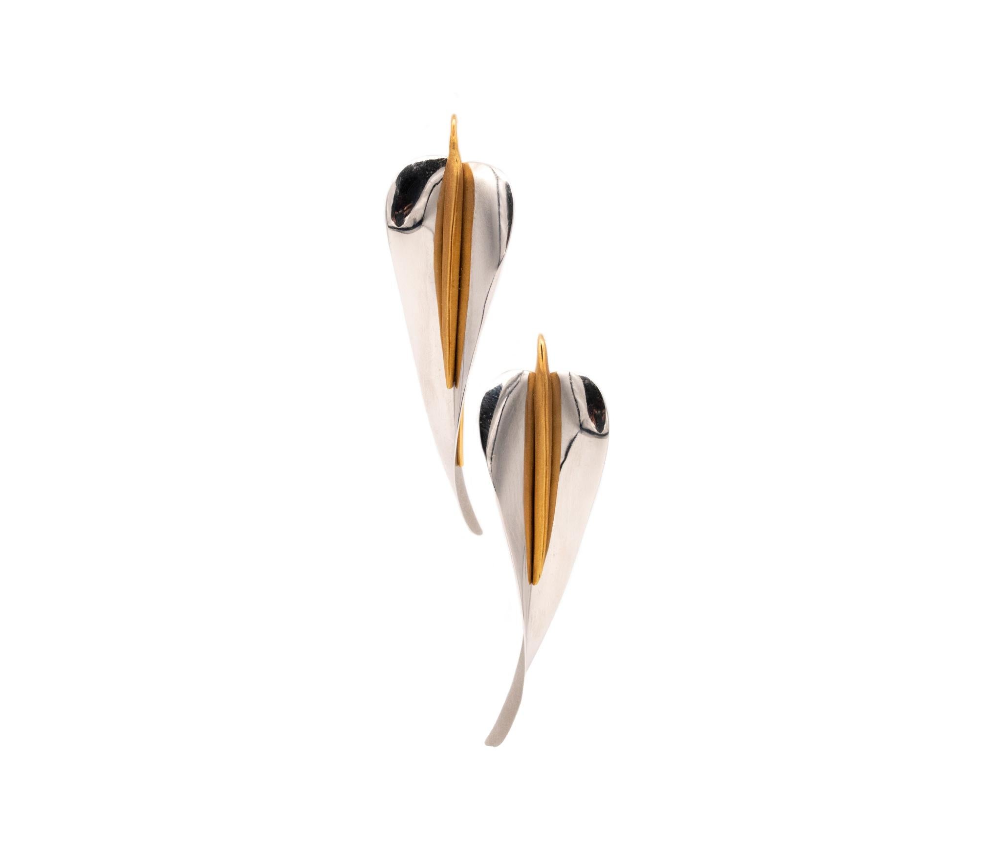 Calla lily drop earrings designed by Michael Good.

A beautiful pair, created with the stylized shape of the lily flower with pistils. They was crafted by the talented goldsmith-artist Michael Good in solid high polished platinum and 18 karats of