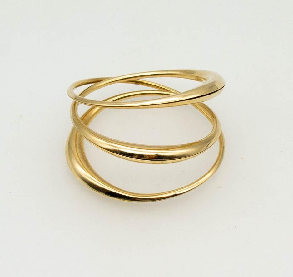 Elegant and spare Michael Good bracelet, consisting of three domes of 18 karat gold in varying thicknesses, all encircling the wearer's wrist.  Signed M Good, 750, inner diameter 2 2/4