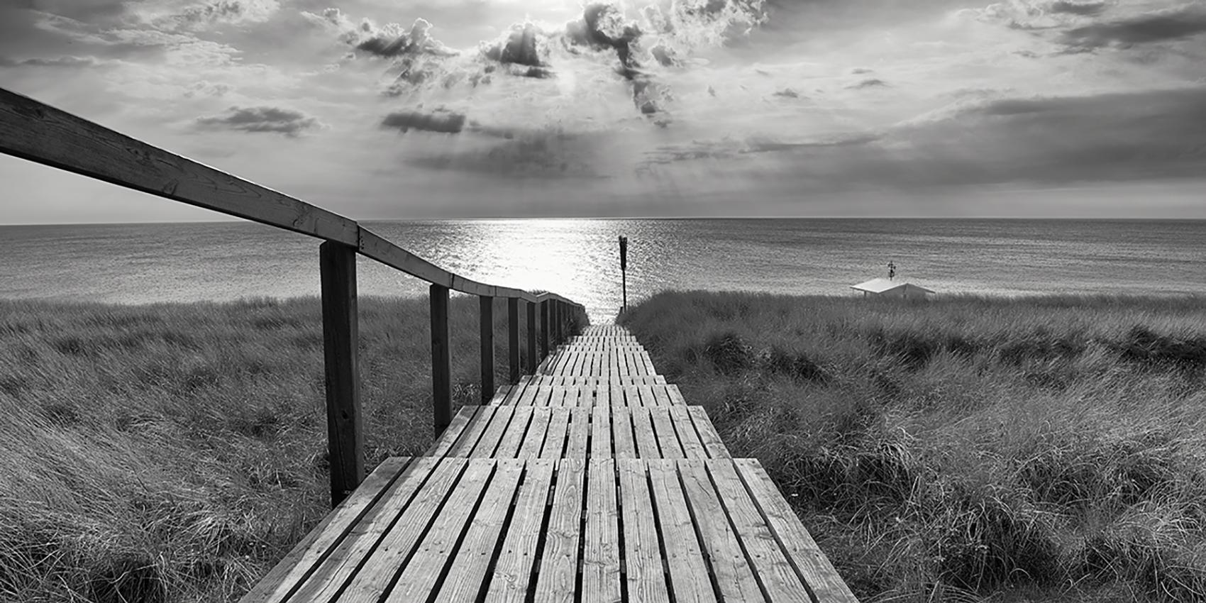 Michael Götze Landscape Photograph - Rantumer Steg - contemporary black/white photography ocean landscape, footbridge