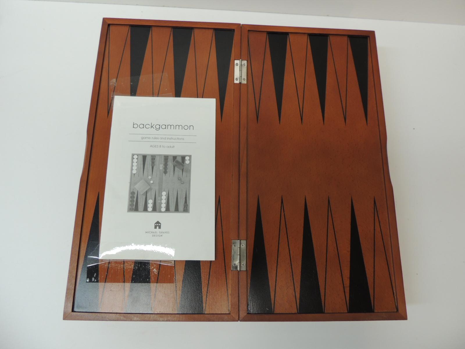 Backgammon board designed by Michael Graves. Imported, circa 2002. Signed with metal tag and includes original box. Beautifully constructed of cherry stained hardwood and veneers. Features legs that fold out to support board and a felt-lined drawer