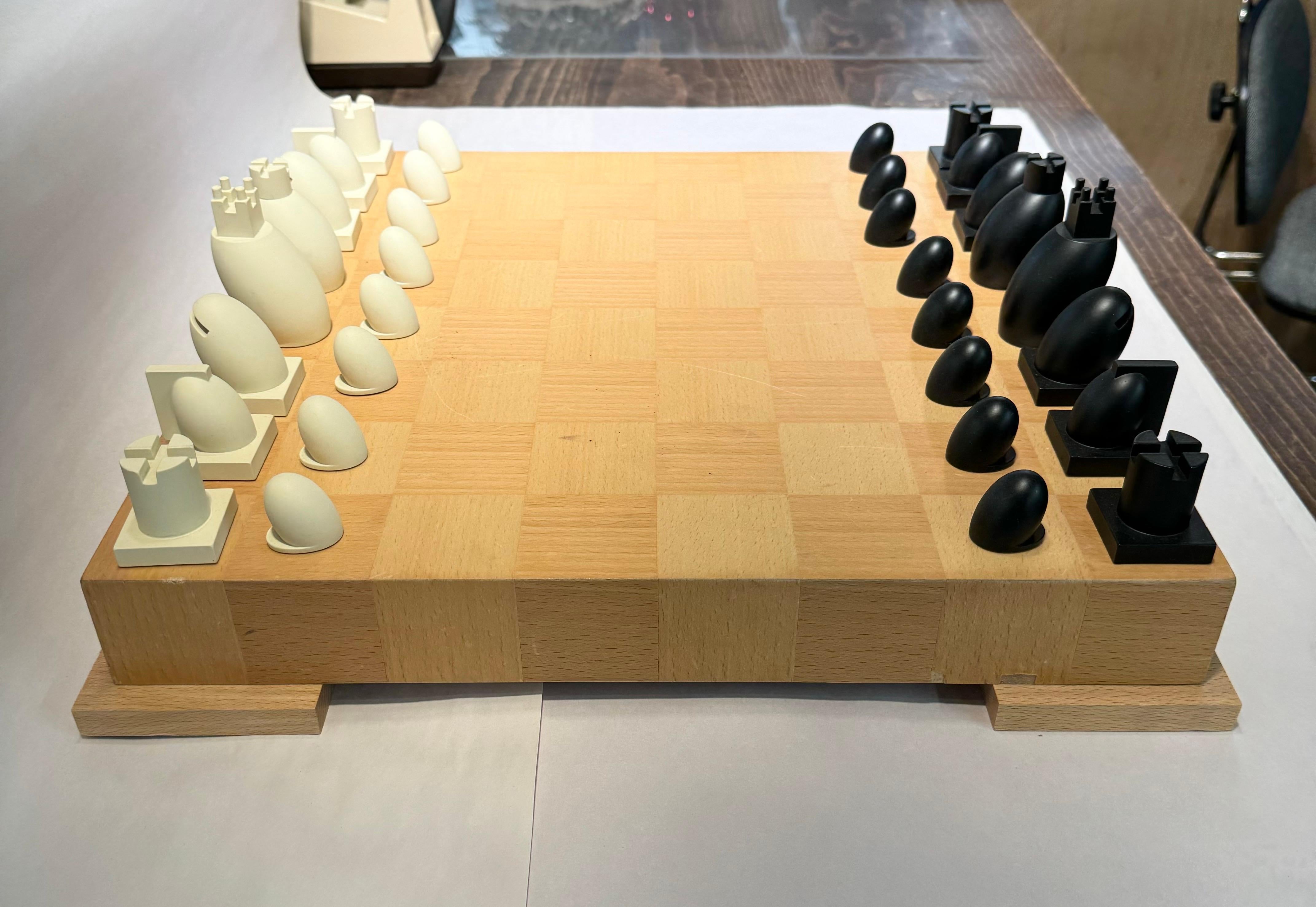 Carved wood chess and checkers set with board and box by famed architect Michael Graves. 

Chess board is marked with Graves tag; each chess and pawn piece is signed Graves; 

USA, circa 2000.

Features resin chess and pawn pieces in faux ebony and