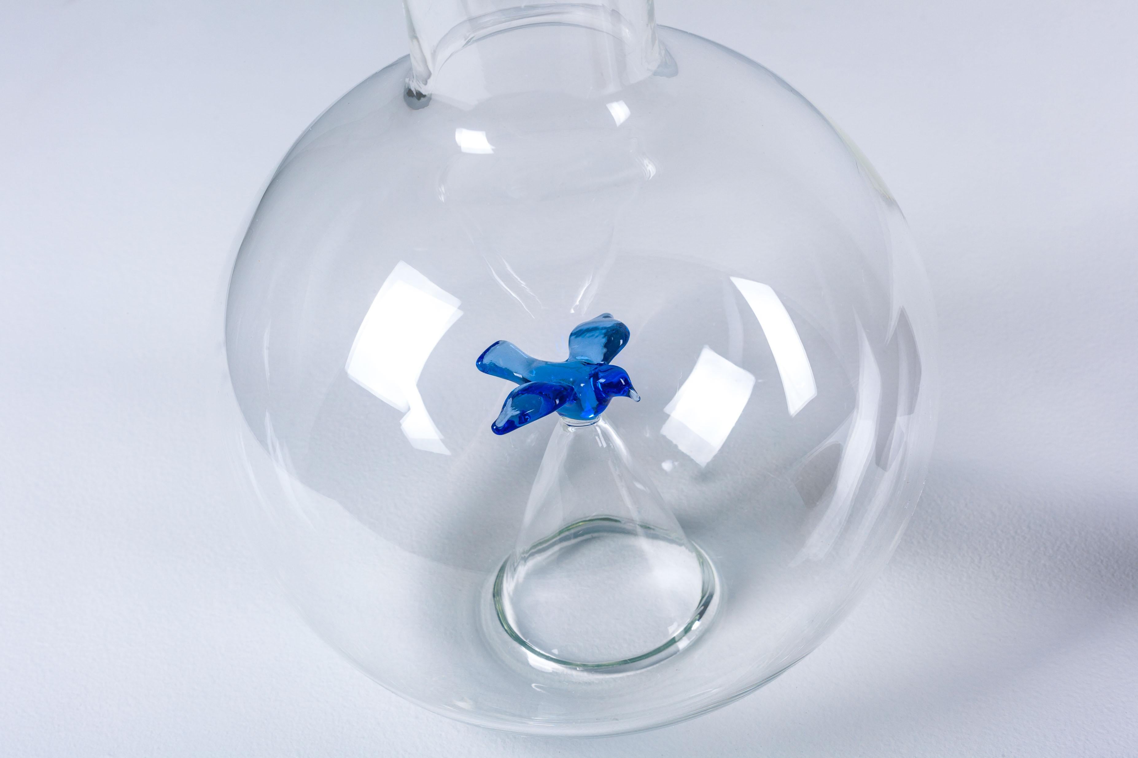 Wine decanter in handblown glass by Michael Graves for JcPenney in 2013 USA. It is a new unused piece that comes with its original box. Decanter: 12 x 6 inches. A remarkably delicate and clever design. The glass blue bird serves as an aerator for