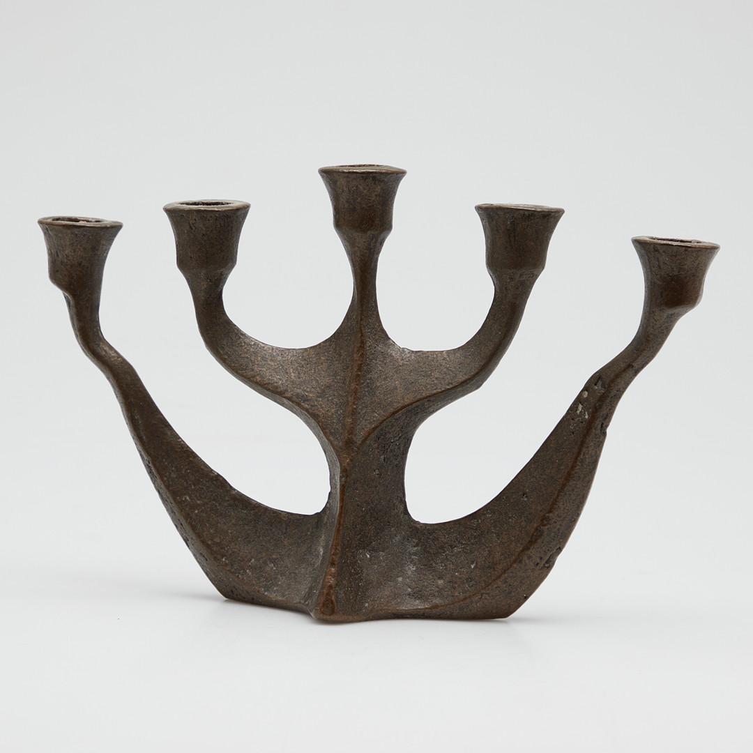 Five-armed sculptural candlestick in bronze by Michael Hael Harjes, made in the 1960s–70s. The piece shows a Brutalist approach with rough, textured surfaces and irregular forms that give it a sculptural quality. Each arm is set at a different