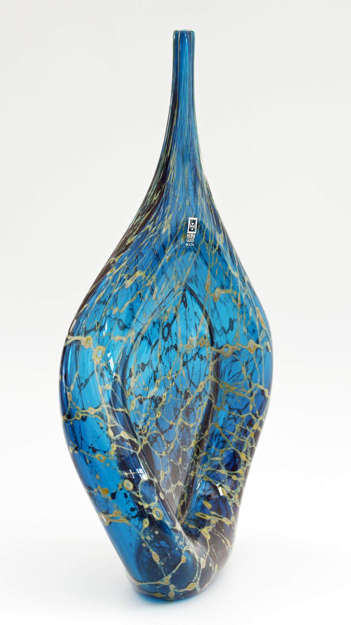 A stylish and scarce vintage Maltese Mdina bottle shaped vase designed by Michael Harris. This tall sculptural shaped vase has a rounded pear drop shaped base with hollowing around the edge and with a flat compressed centre and narrow pulled neck.