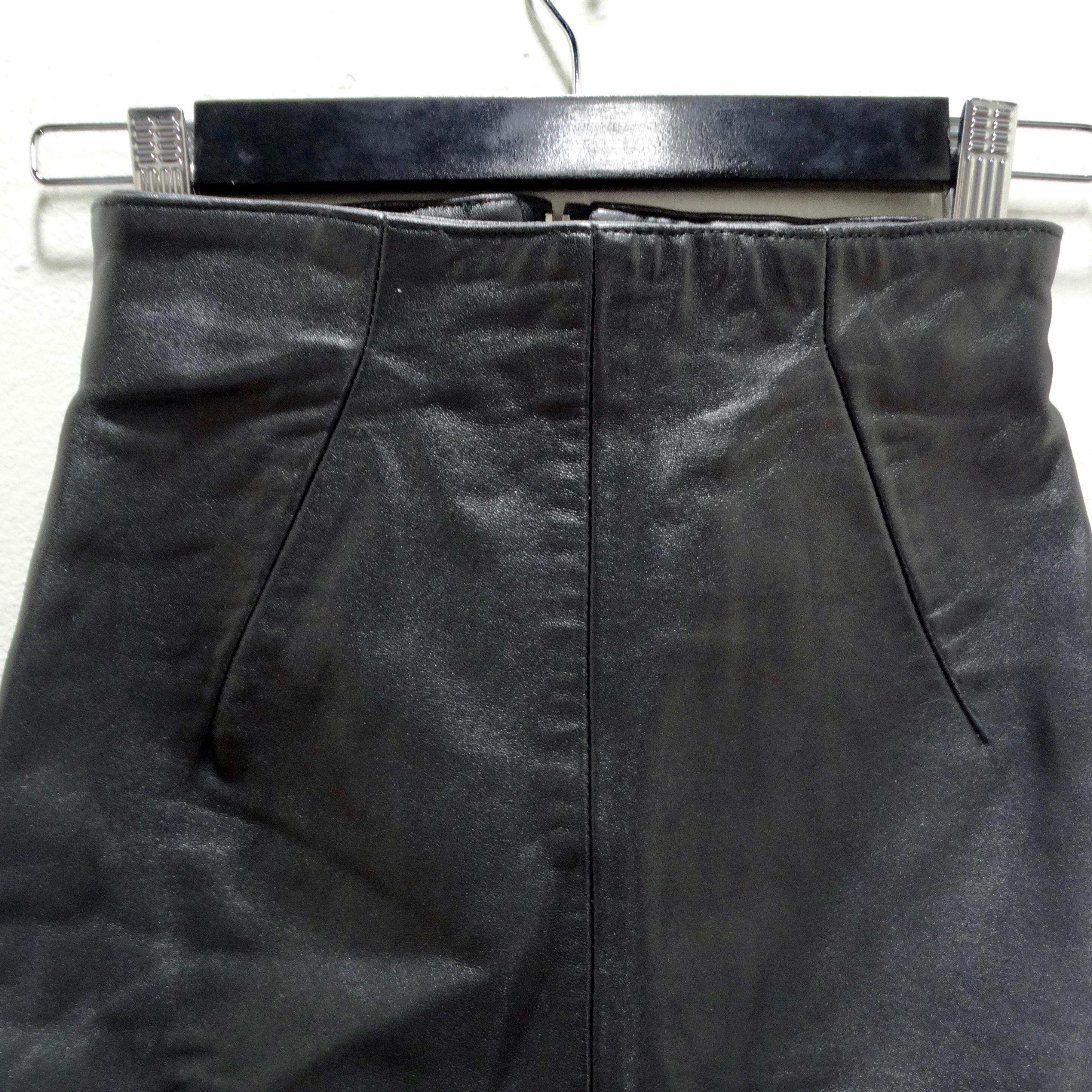 The Michael Hoban 1980s Black Leather Mini Skirt is a striking and versatile piece that seamlessly blends timeless elegance with a touch of edgy flair. Crafted with precision and attention to detail, this mini skirt is designed to be a wardrobe