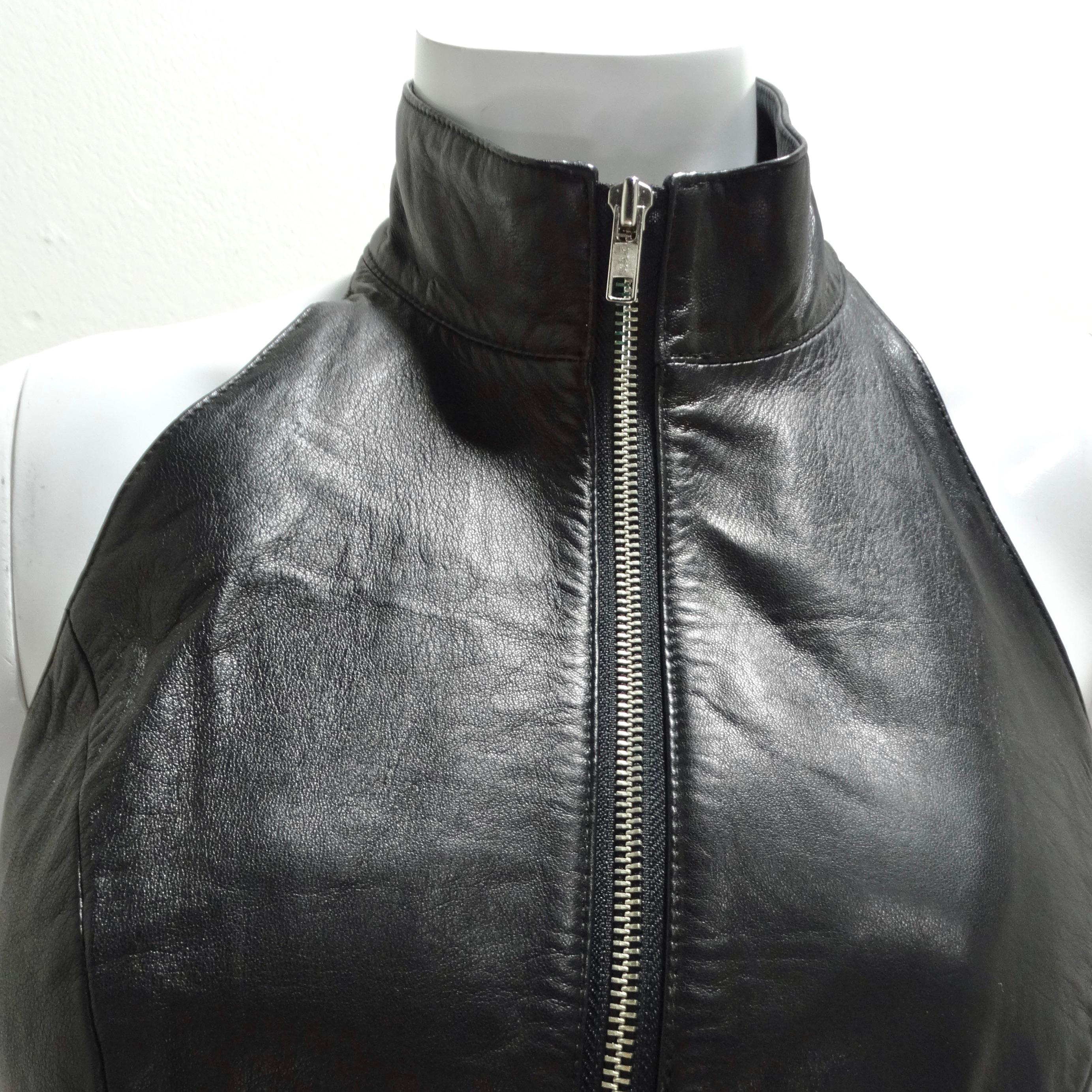 Get your hands on the Michael Hoban 1980s Black Leather Zip-Up Top – a chic and edgy wardrobe essential that effortlessly marries timeless style with a touch of daring flair. This adorable black leather crop top is a versatile piece designed to make