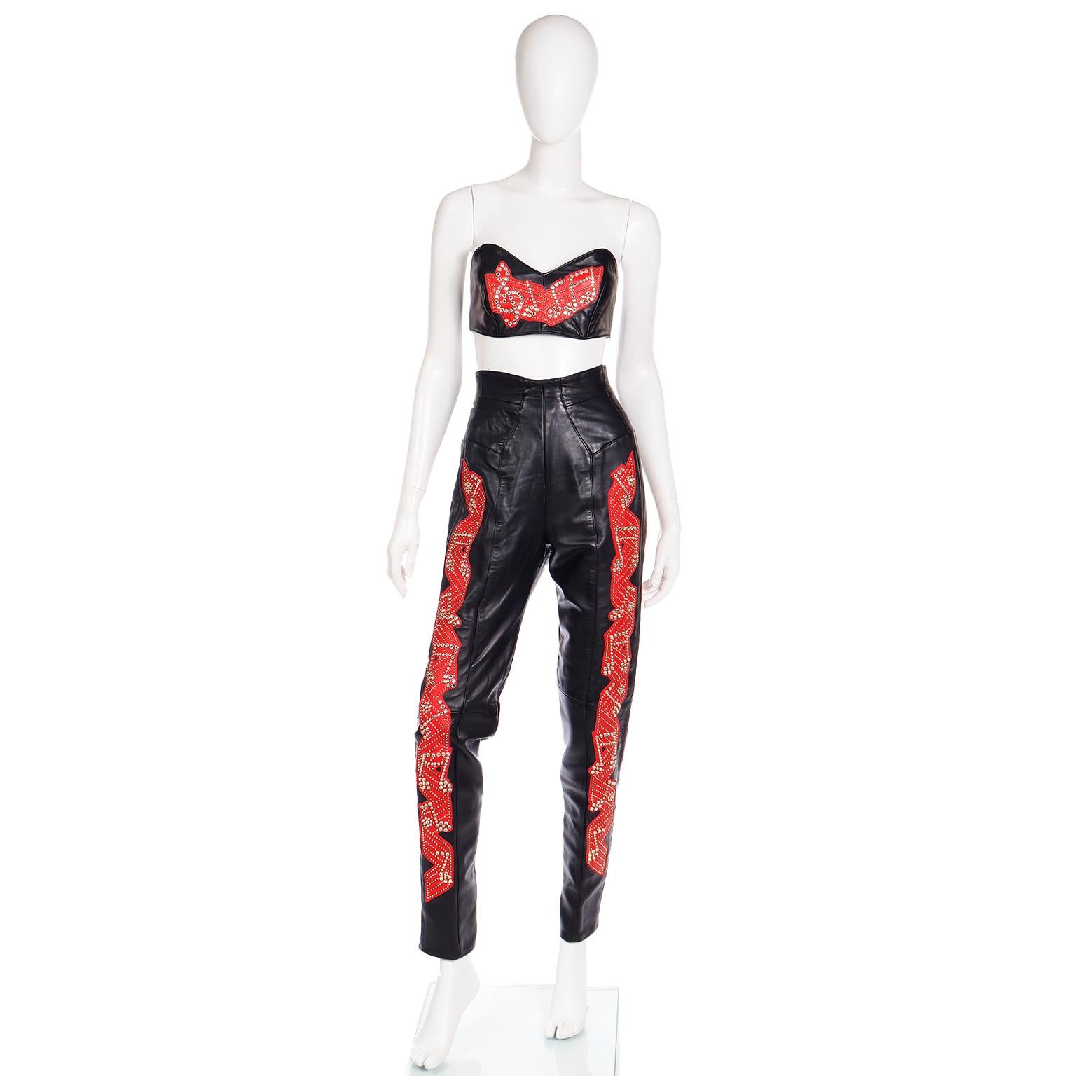 This is a truly one of a kind vintage 1980's Michael Hoban for North Beach leather 3 piece red music theme leather outfit! This show stopping ensemble includes a pair of high waisted leather pants, a bustier, and a jacket. All have red appliques