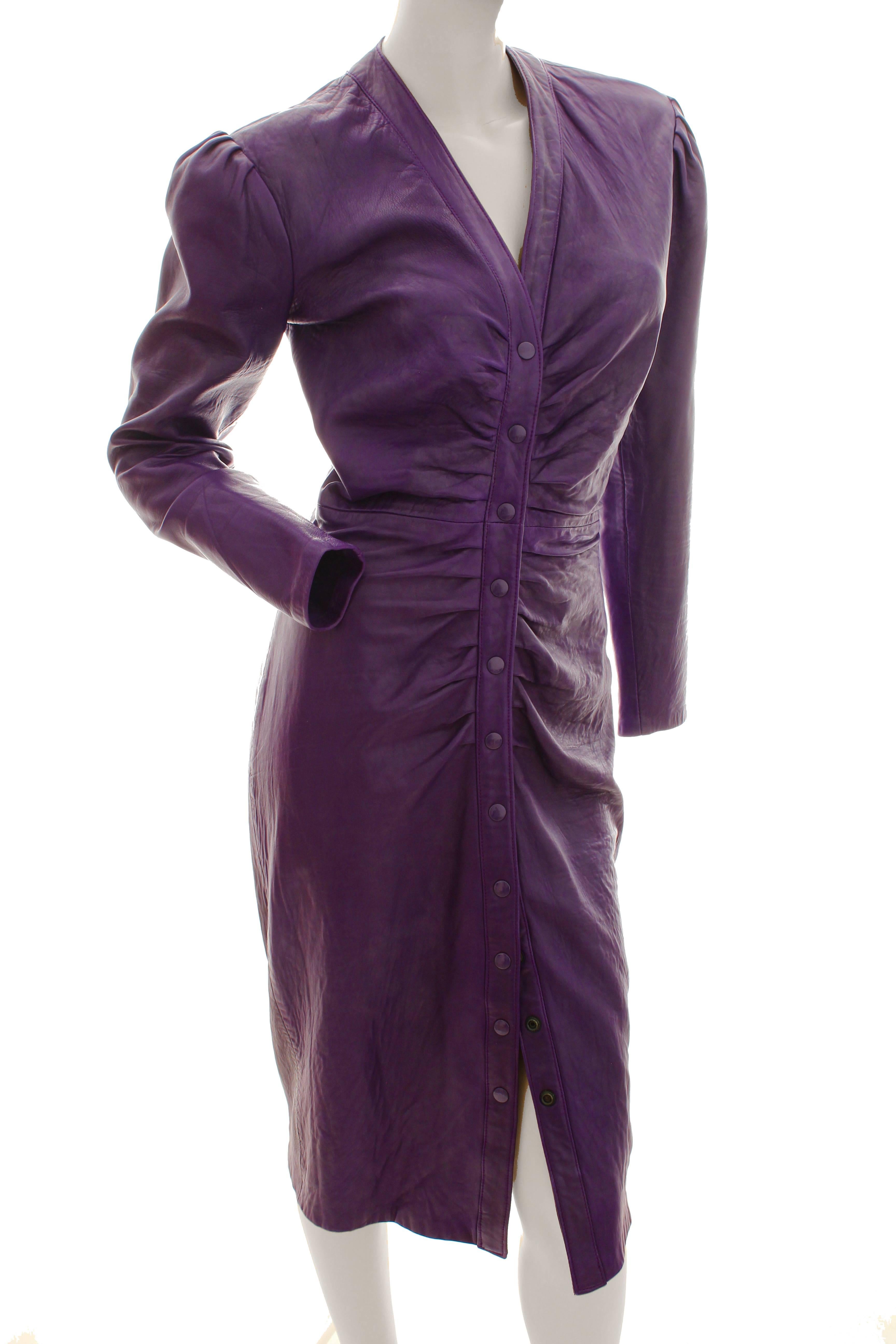 This sleek leather dress was made by North Beach Leather, most likely in the early 1980s.  Made from a true purple leather, this piece hugs ones curves and fastens with snaps from the bust to the hem.  In excellent vintage condition with minimal