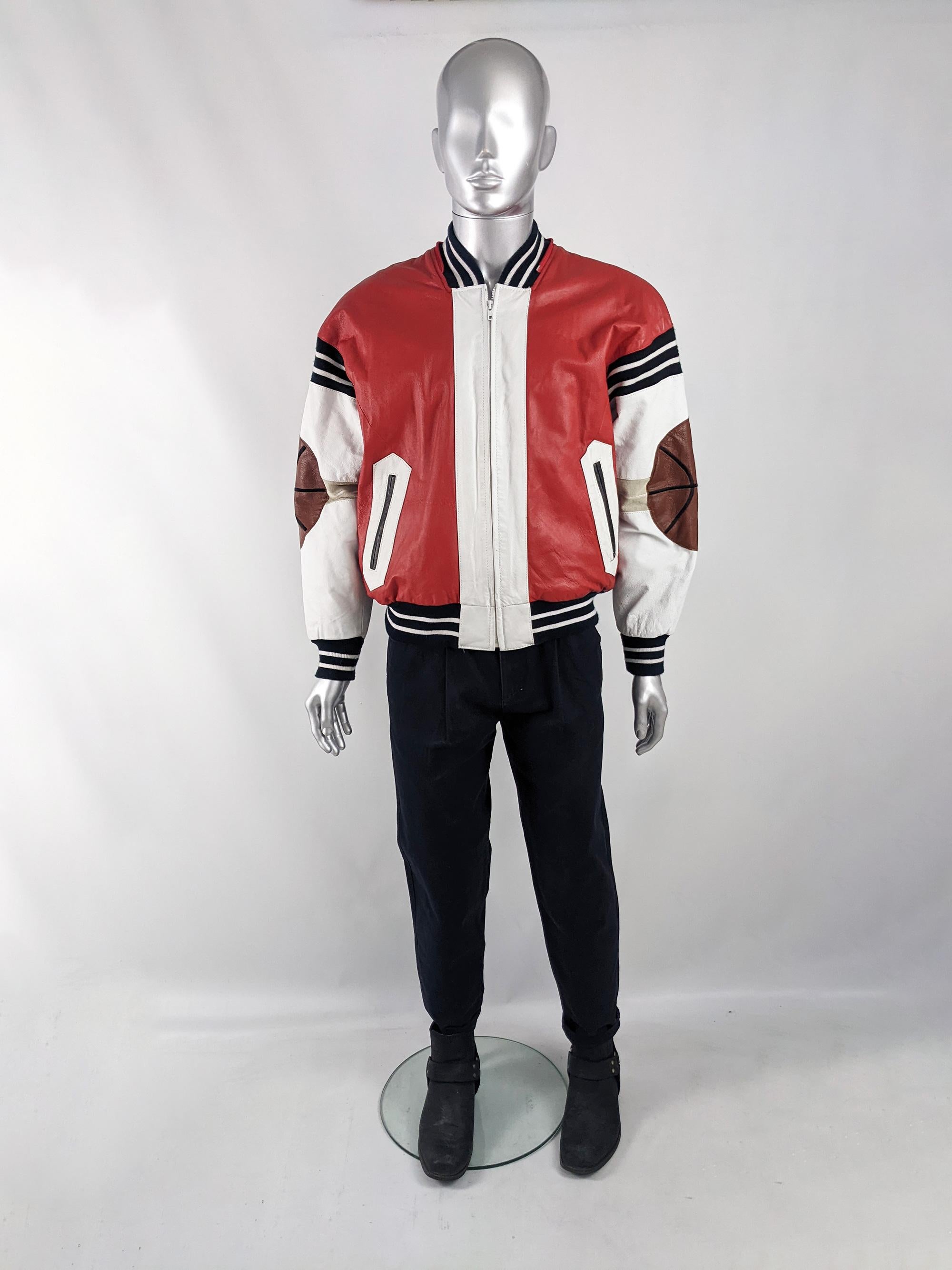 An incredible and rare vintage mens leather bomber jacket from the 80s by luxury American leatherwear designer, Michael Hoban. In a red and white leather with amazing basketball leather appliques throughout. It has an oversized fit and a quilted