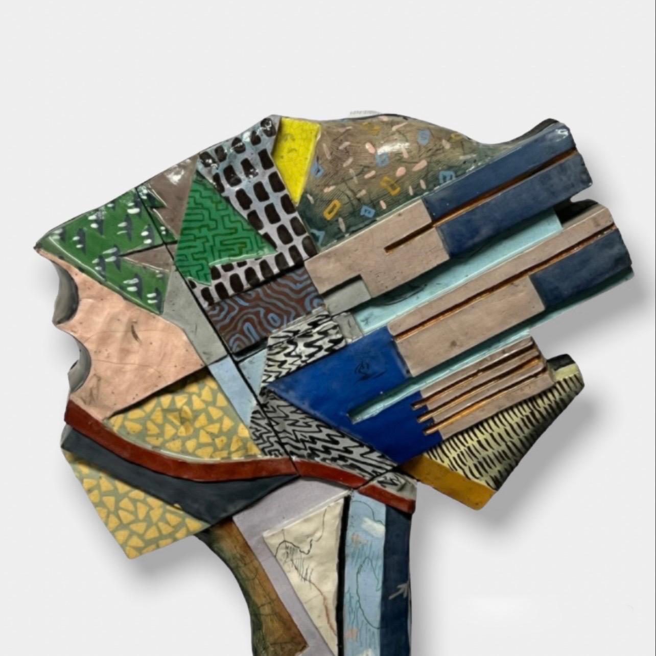 Fantastic Memphis-style ceramic wall sculpture by artist, Michael Hough c1990, titled, “Megalopolised”. (47” x 21” x 3.5”)

Hough has been creating ceramic pottery and steel sculptures for the past 35+ years. His art career began during his second