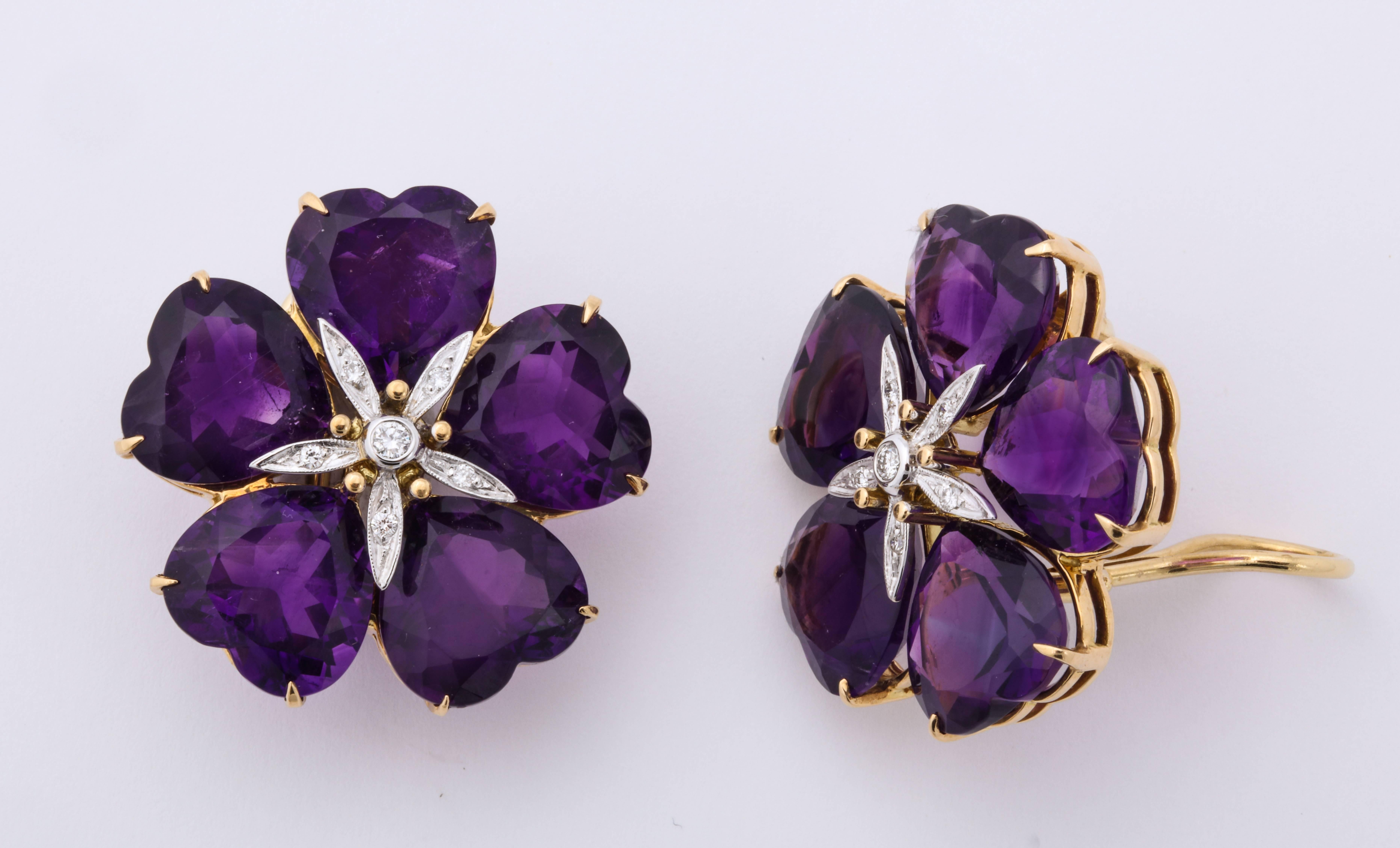 Vibrant purple heart shaped amethysts are carefully configured around a diamond center to form a beautiful flower.  Just large enough to make the right impact, without being too heavy, these wonderful earclips are easily wearable- daytime or