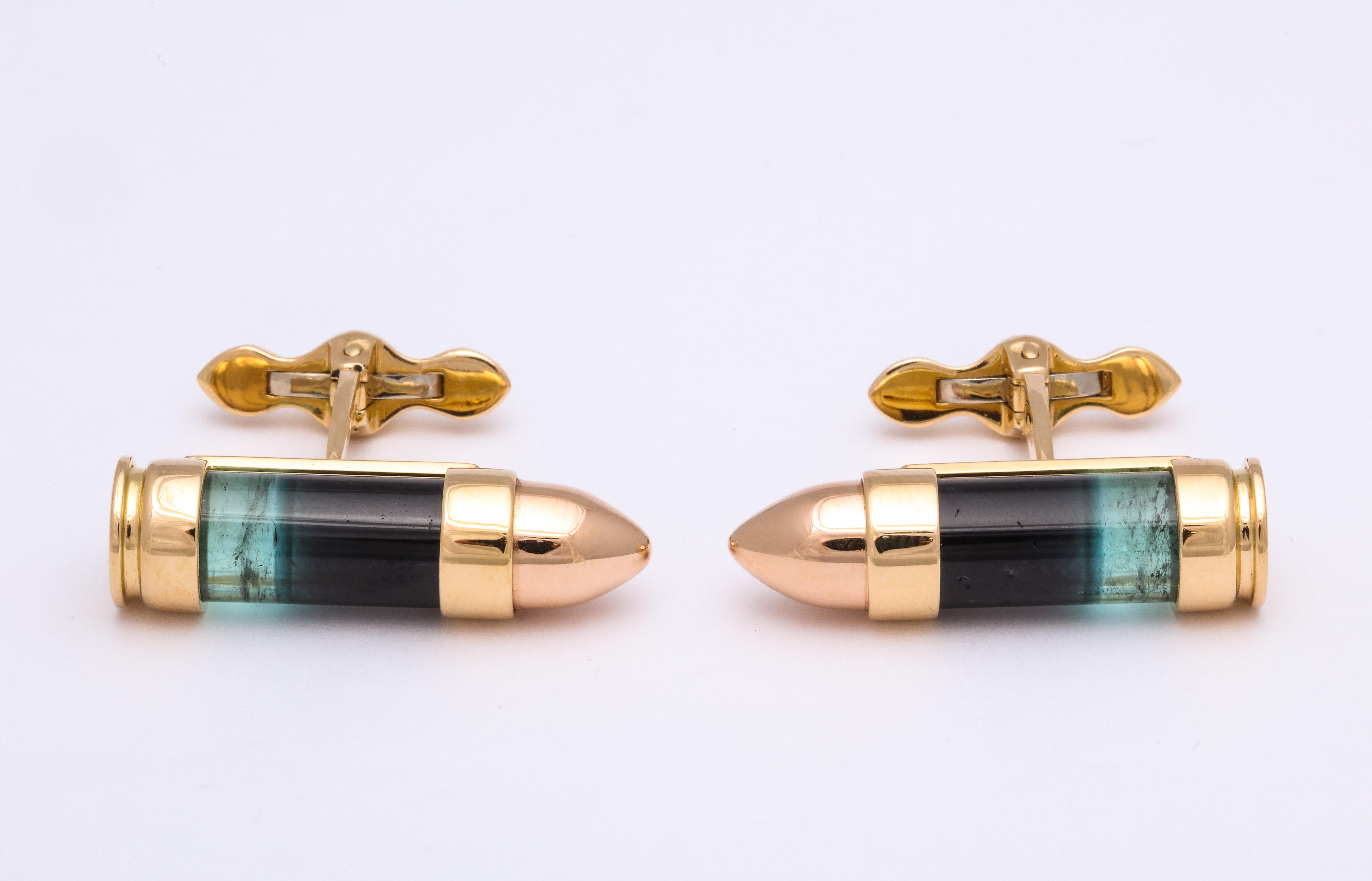 It's all in the details!
This completely one of a kind pair of cufflinks features a pair of cylindrical natural Brazilian bi-color tourmalines.  The combined green and black occur in the rough material and the expert stone cutter was able to make a