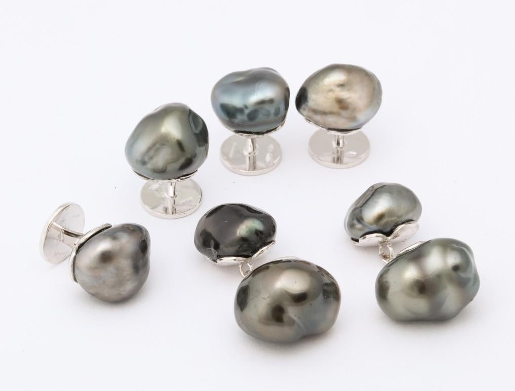Forming spontaneously during the culturing process, keshi pearls are considered to be the ultimate treasures.  They exhibit higher luster than other pearls and their unique shapes are quite stylish.  This one of a kind set features handmade settings