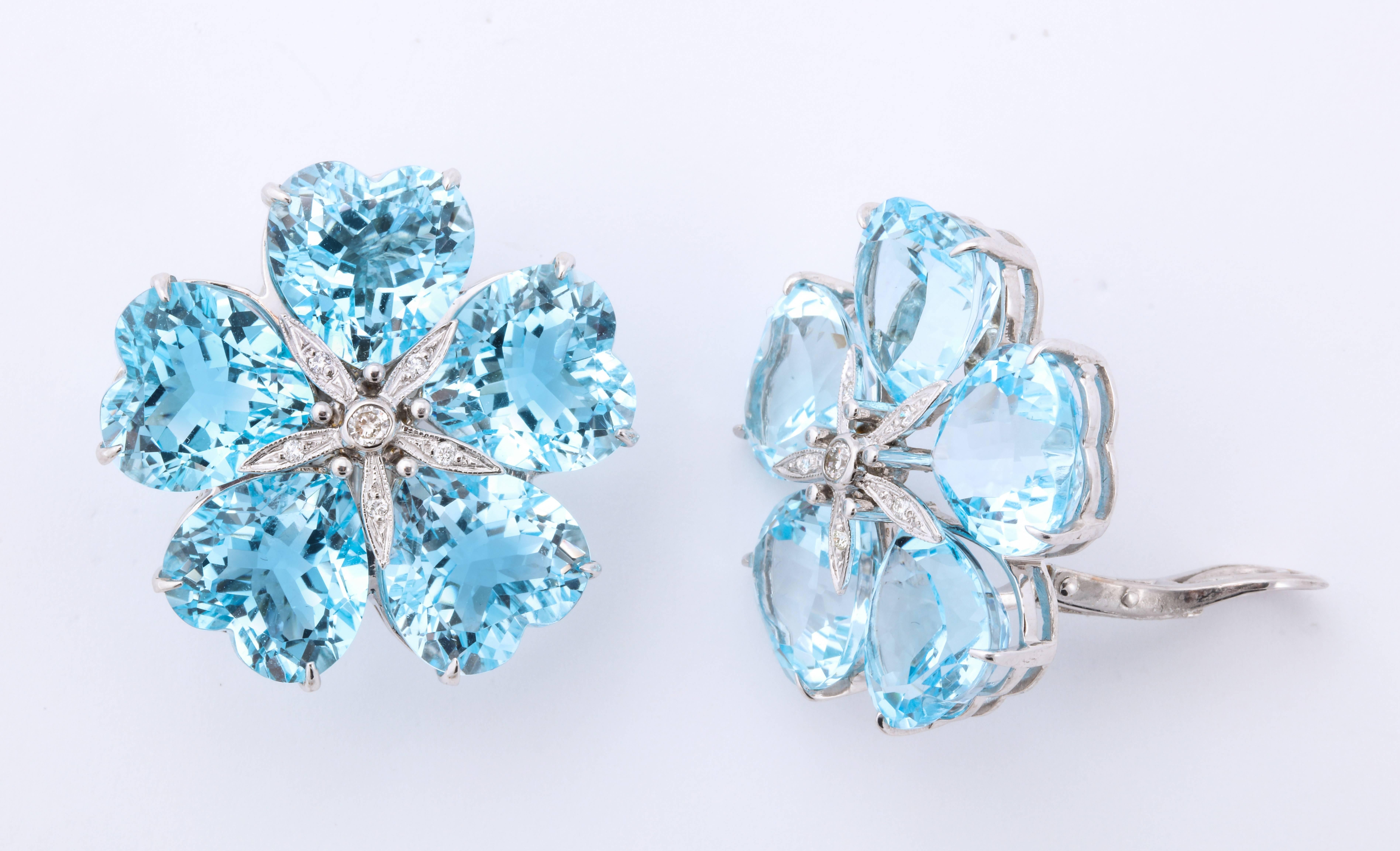 The brightest blue, heart shaped topazes are carefully configured around a diamond center to form a beautiful flower.  Just large enough to make the right impact, without being too heavy, these wonderful earclips are easily wearable- daytime or