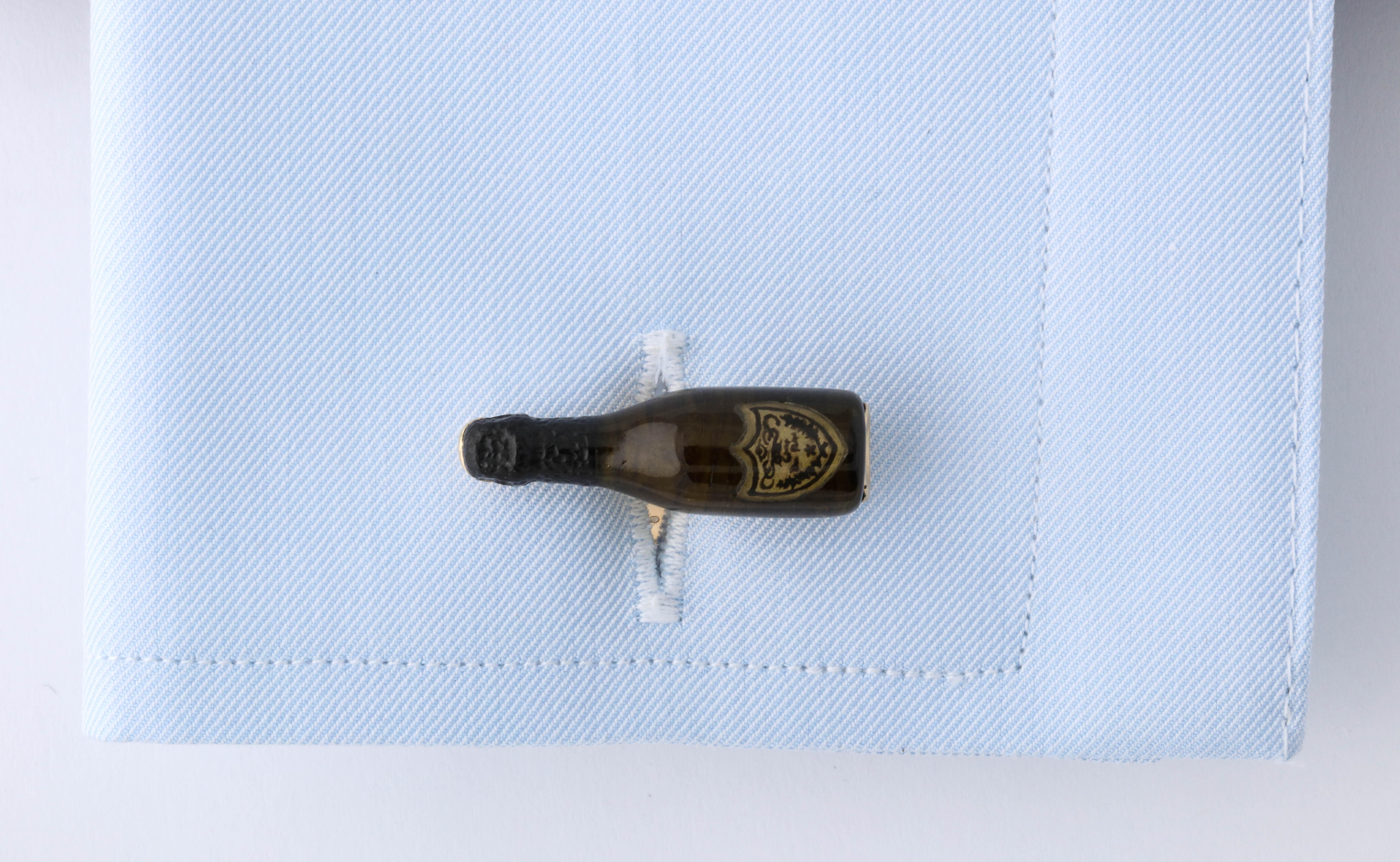 These are truly the most unique champagne bottle cufflinks around. The body of the bottle is expertly shaped from green tourmaline by a master stone carver. The top of the bottle, which is traditionally covered in black foil, is carved from black